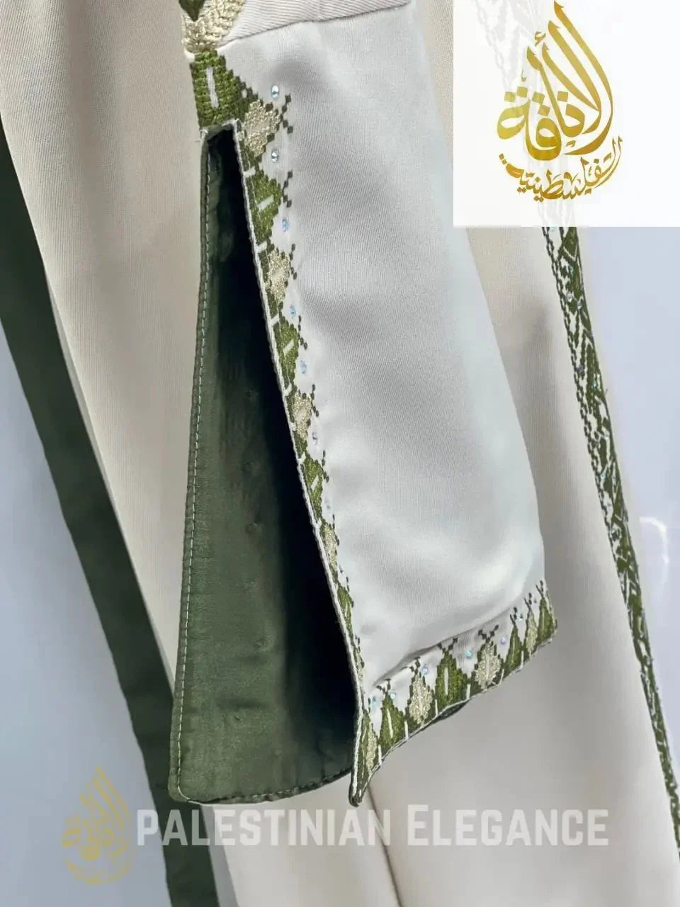 Close-up of sleeve detail on Palestinian embroidered thoub with olive green and cream embroidery by Palestinian Elegance