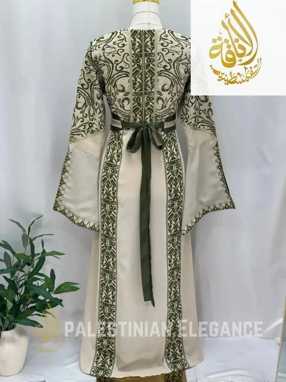 Palestinian embroidered thoub in cream with green detailed embroidery and waist tie by Palestinian Elegance