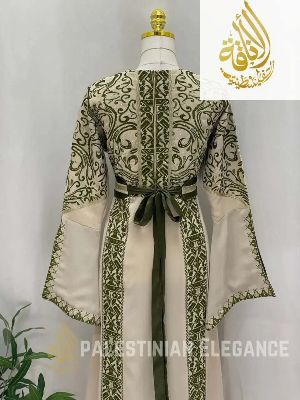 Back view of a traditional Palestinian embroidered thoub with green intricate embroidery and sash belt