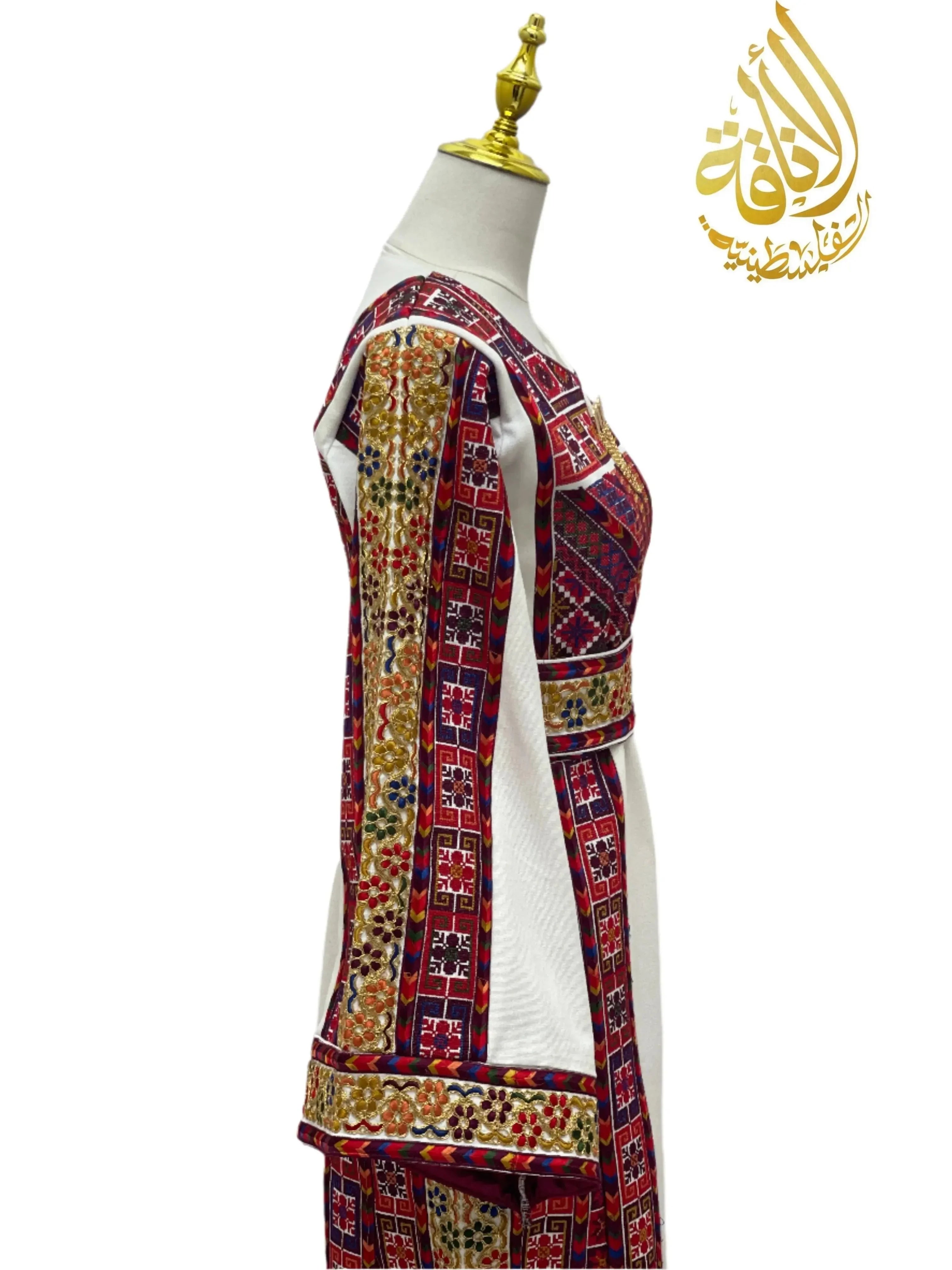 Azhar Atameen Embroidered Thoub by Palestinian Elegance with intricate red and gold embroidery on white fabric