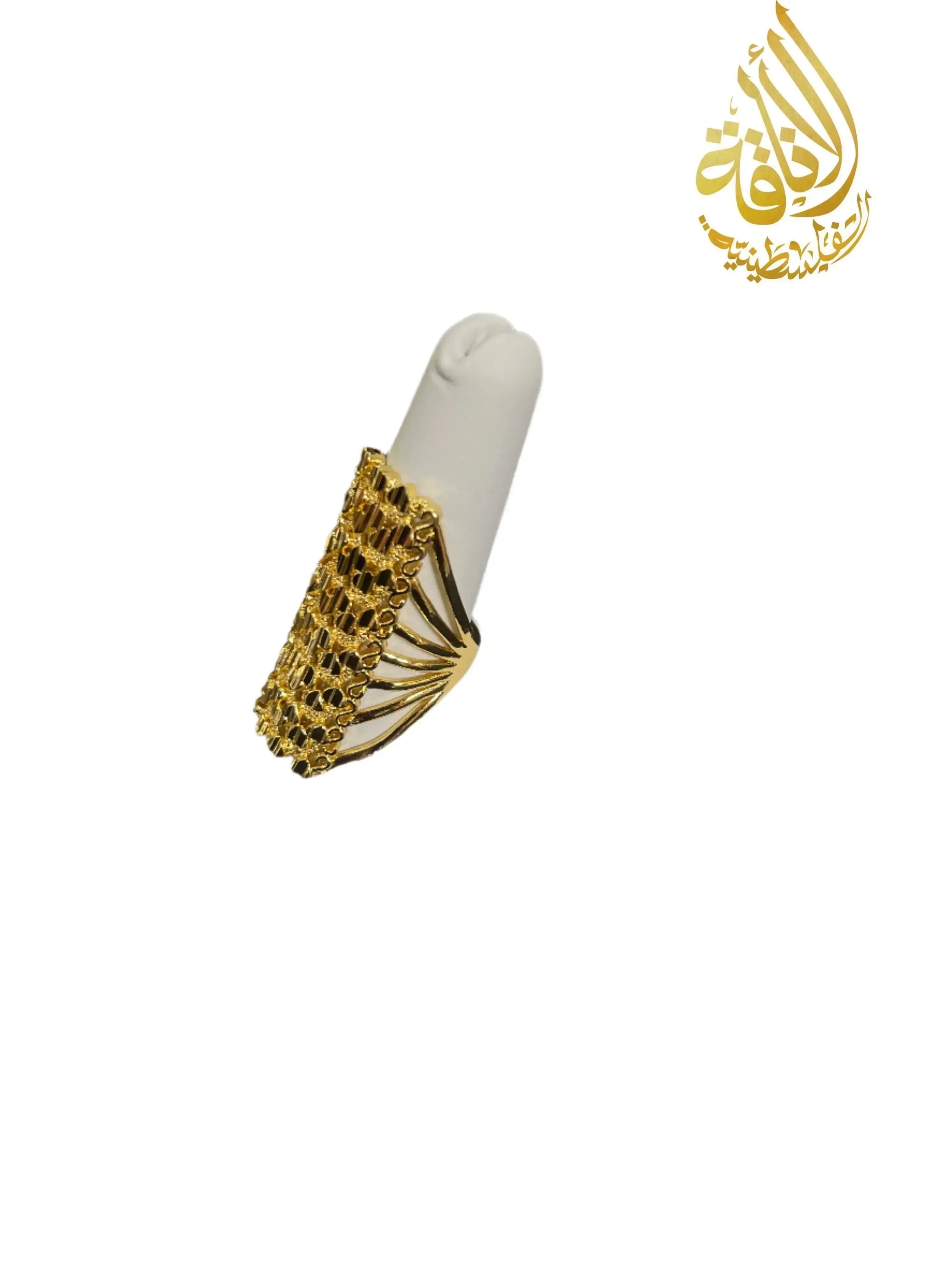 Elegant gold layered ring from Palestinian Elegance with intricate imitated gold design on white display