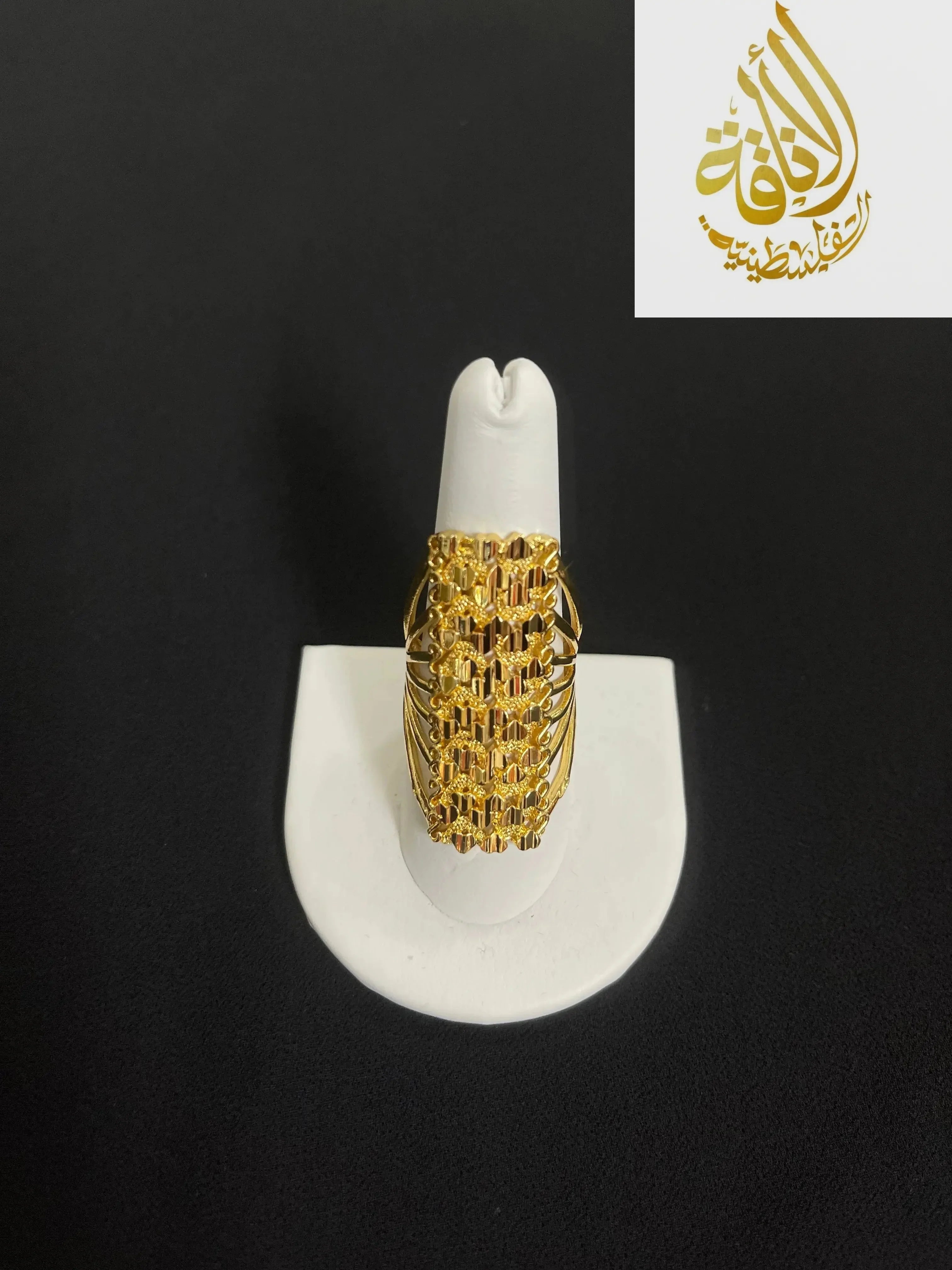 Elegant gold layered ring in imitated gold by Palestinian Elegance displayed on white ring holder
