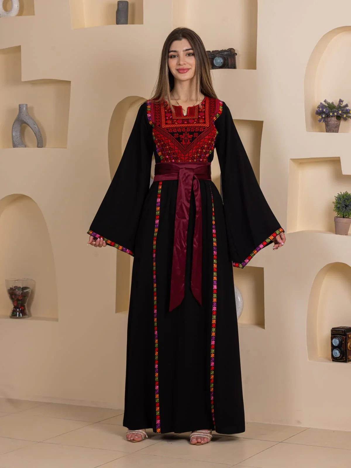 Blossom Embroidered Thobe by Palestinian Elegance black dress with red floral embroidery maroon sash belt and colorful trim