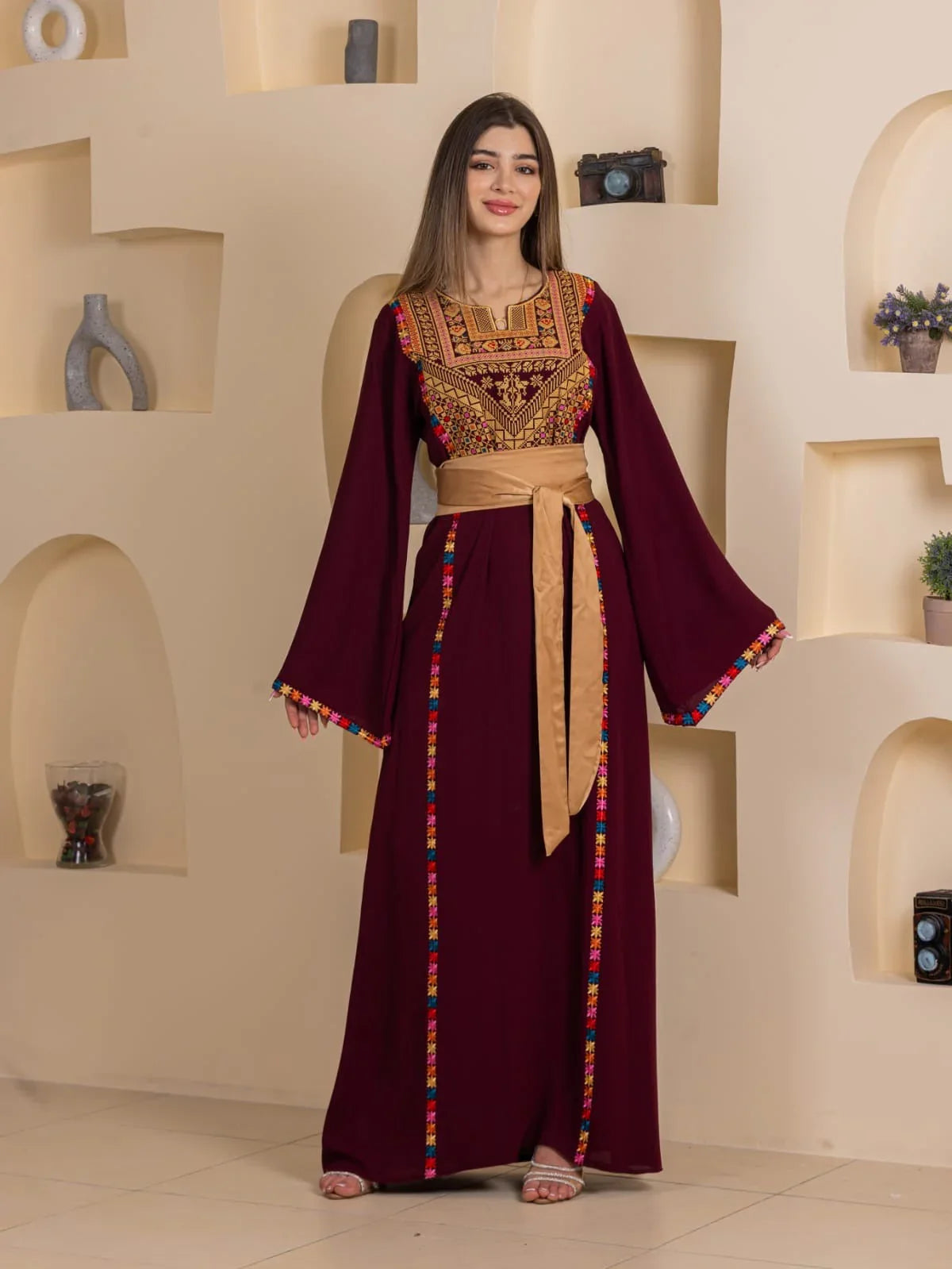 Blossom Embroidered Thobe by Palestinian Elegance maroon gown with intricate gold and multicolor chest embroidery and waist sash