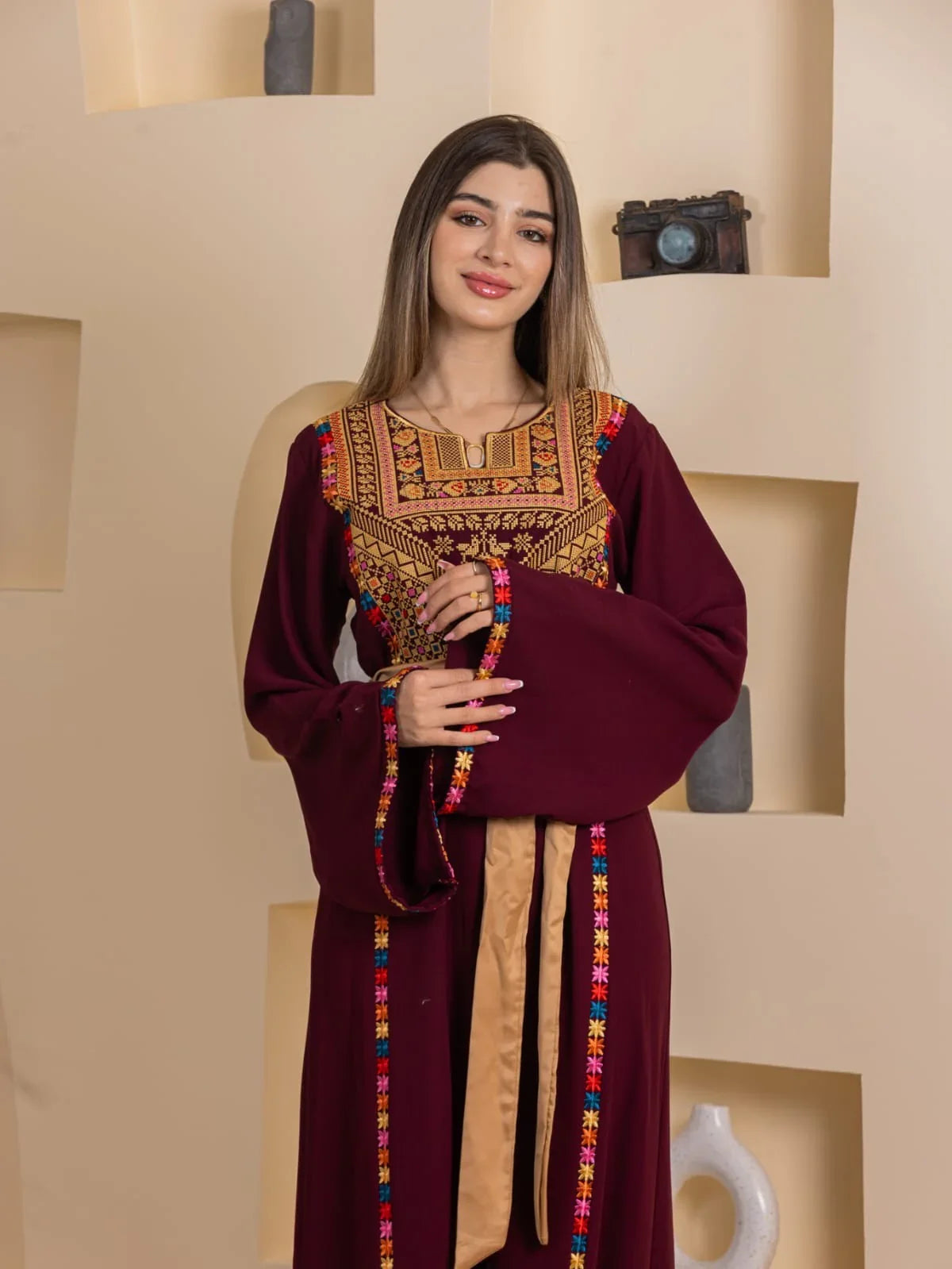Blossom Embroidered Thobe by Palestinian Elegance burgundy thobe with ornate chest embroidery and colorful trim