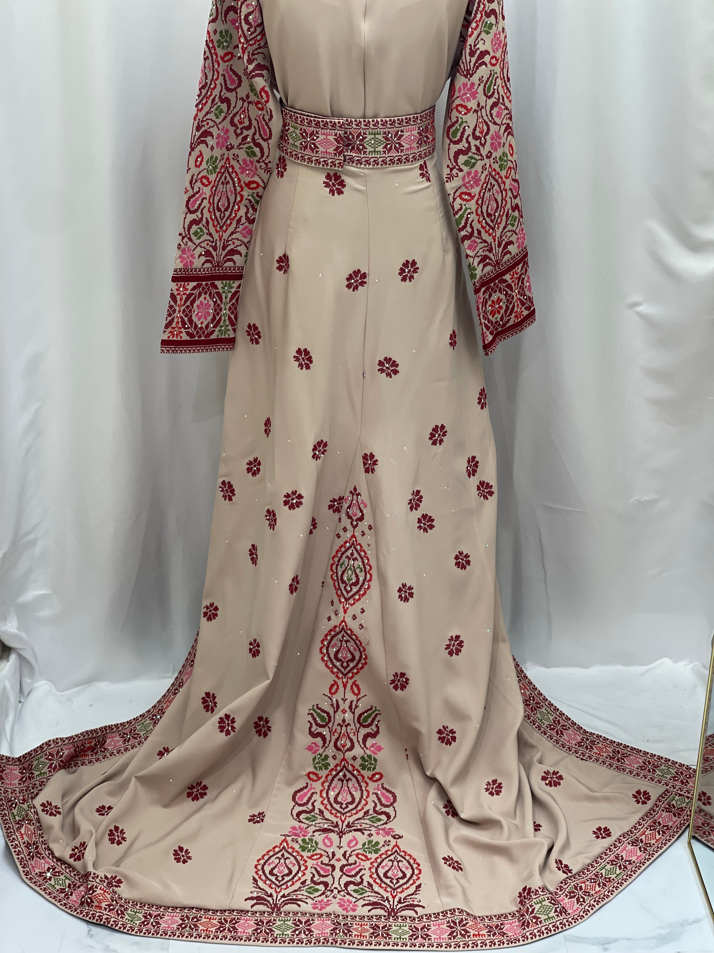 Bride of Roses Thobe featuring detailed embroidered floral patterns in red and green on a soft beige fabric