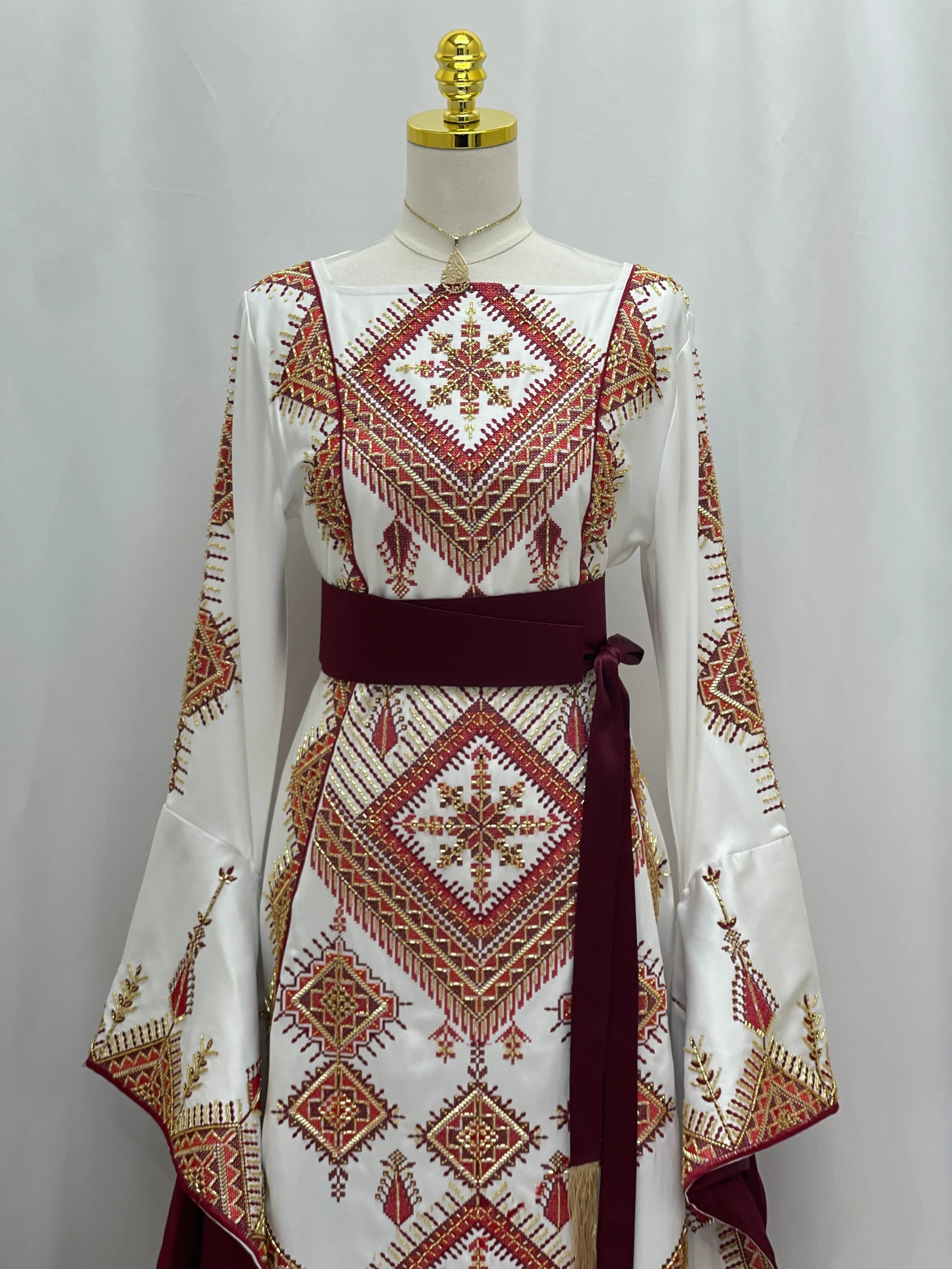 Palestinian Elegance Orient Modren Embroidered Dress white thobe with red and gold geometric embroidery and burgundy sash