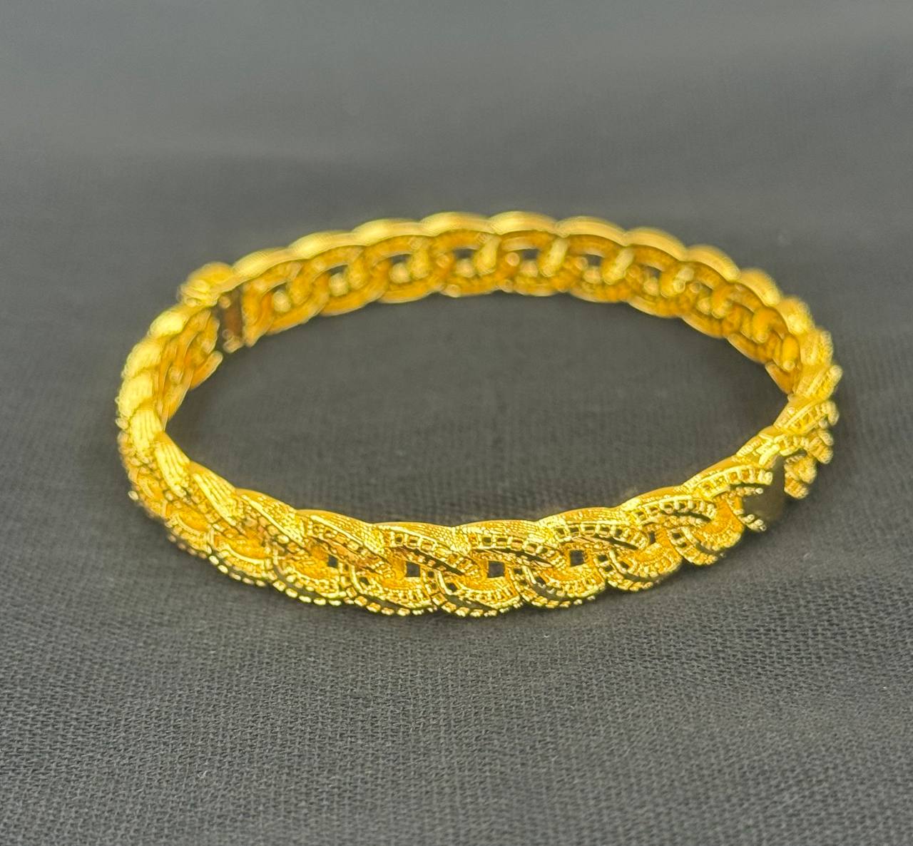 Imitated gold classic gold bangle bracelet with intricate braided design by Palestinian Elegance