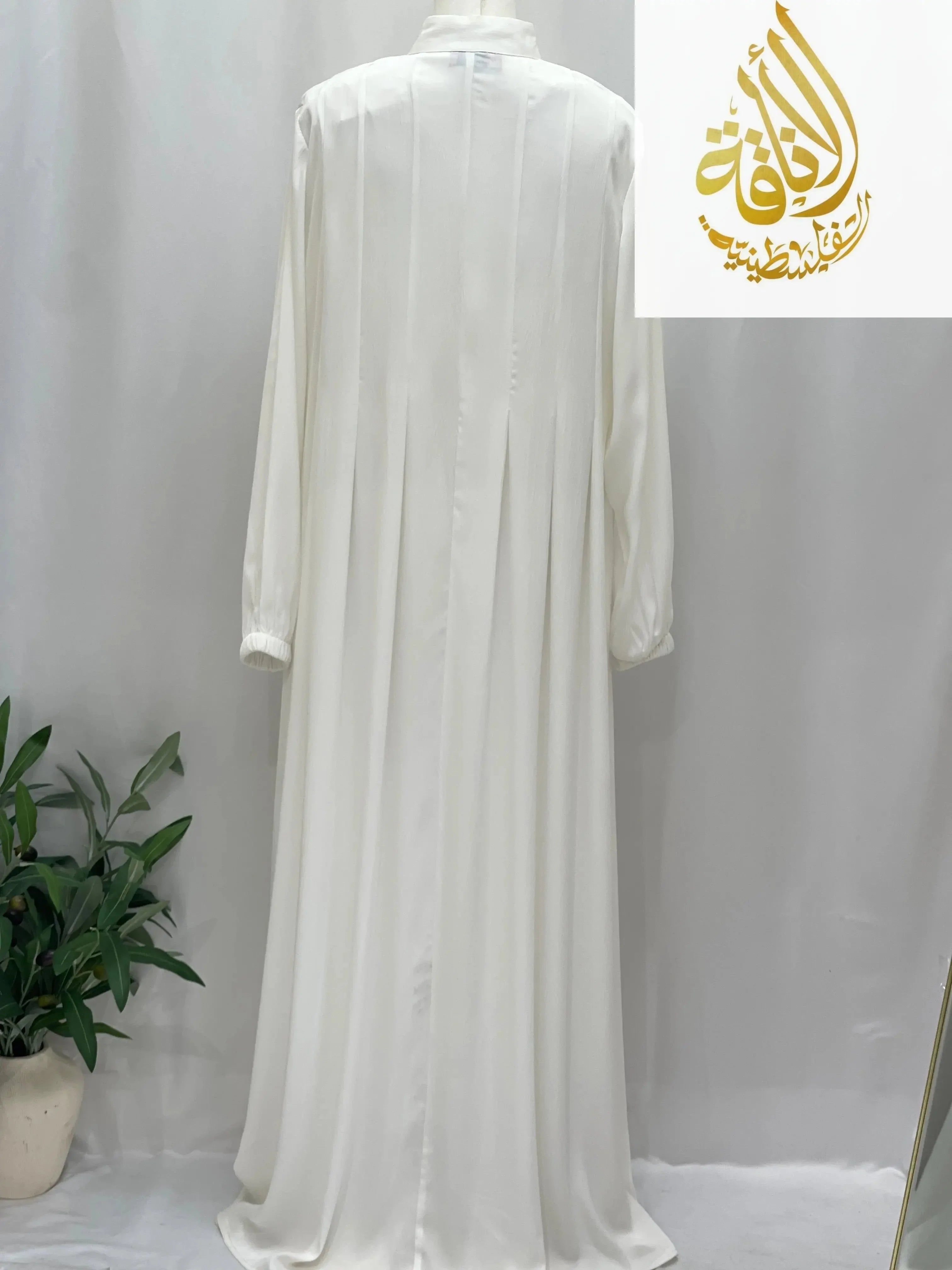 Back view of classic white abaya from Palestinian Elegance with long sleeves and pleated details