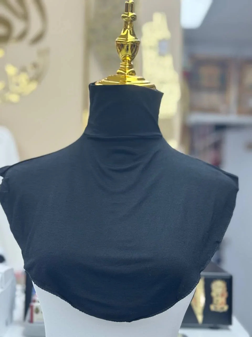 Black Cotton Lightweight Turtle Neck drape on gold topped mannequin showing neck and shoulder coverage by Palestinian Elegance