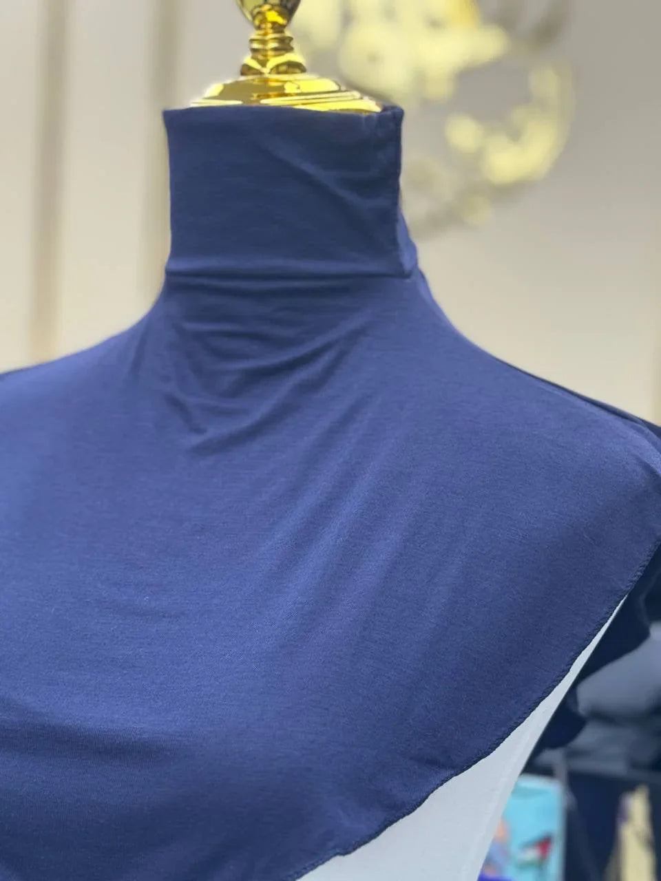Palestinian Elegance navy blue Cotton Lightweight Turtle Neck displayed on gold top mannequin torso