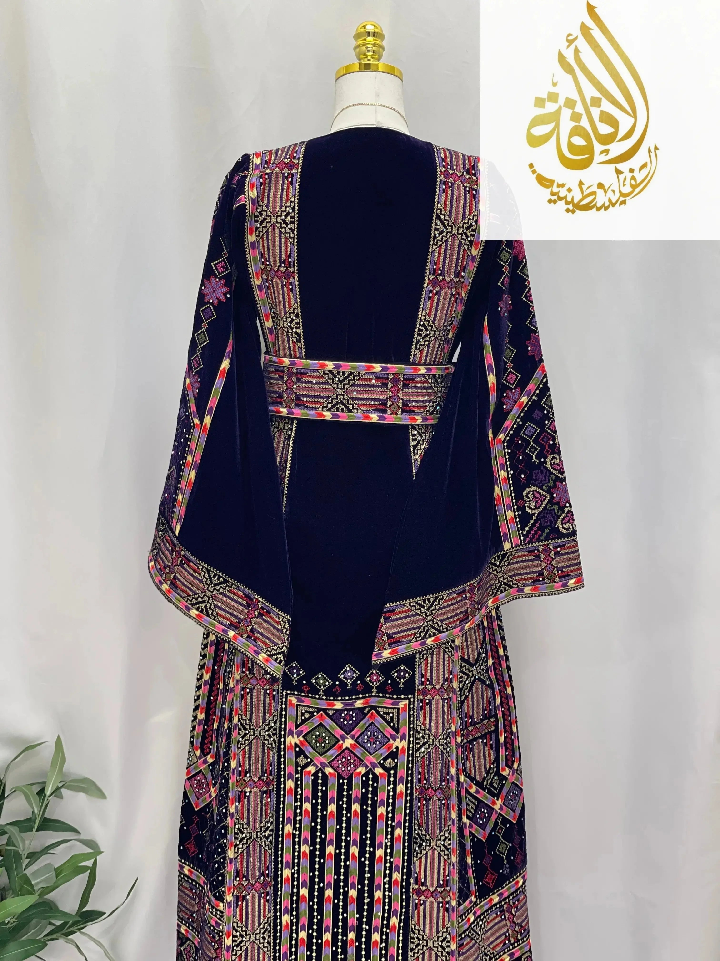 Palestinian Elegance embroidered velvet thoub featuring intricate colorful embroidery on navy velvet fabric