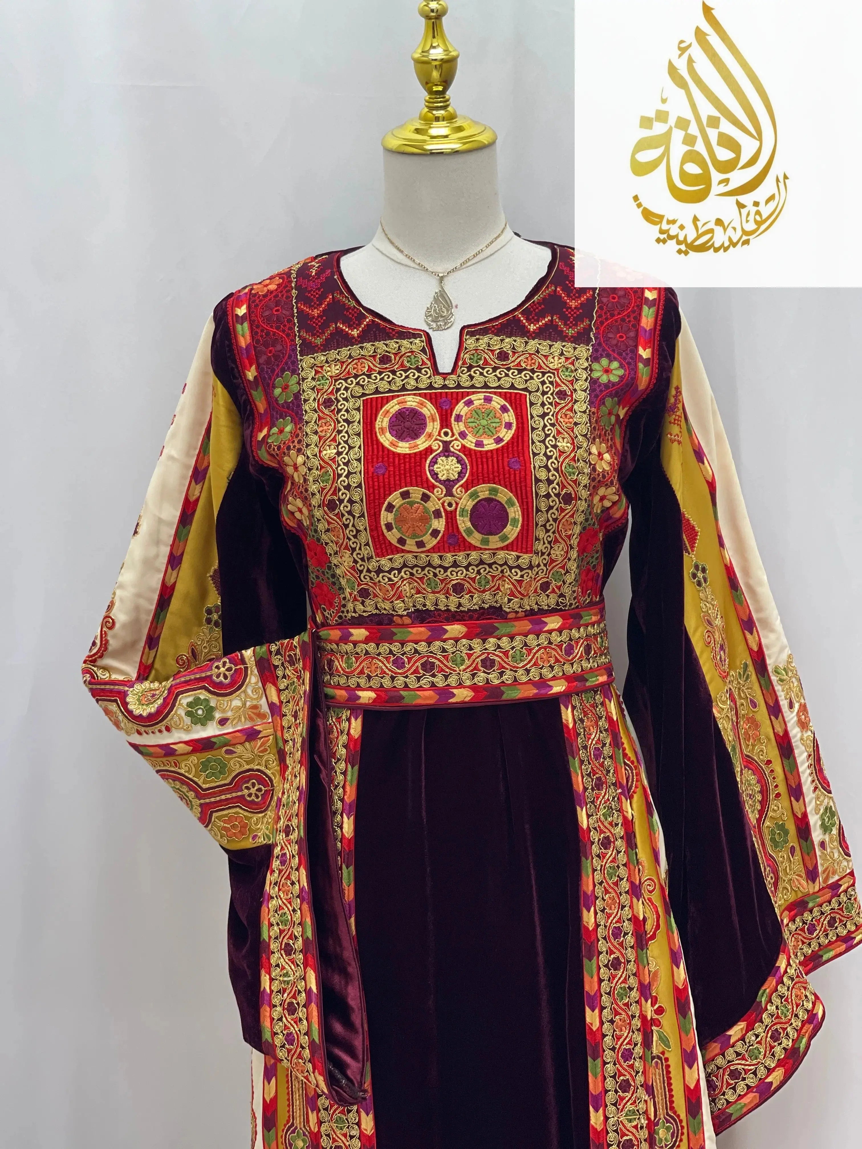 Deep Burgundy Palestinian Embroidered thobe with intricate gold and red patterns on sleeves and bodice by Palestinian Elegance