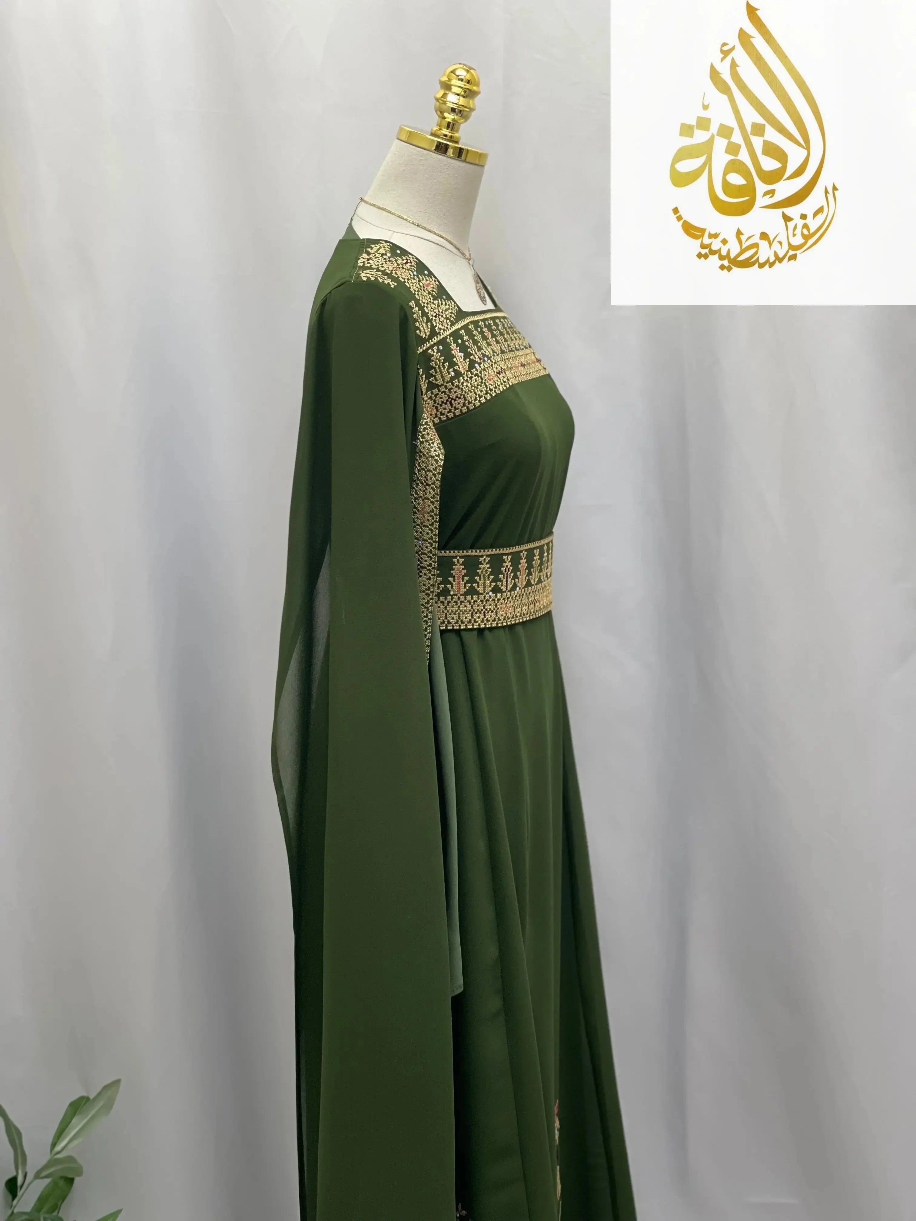 Green embroidered Palestinian dress with gold detailed stitching on bodice and waist by Palestinian Elegance