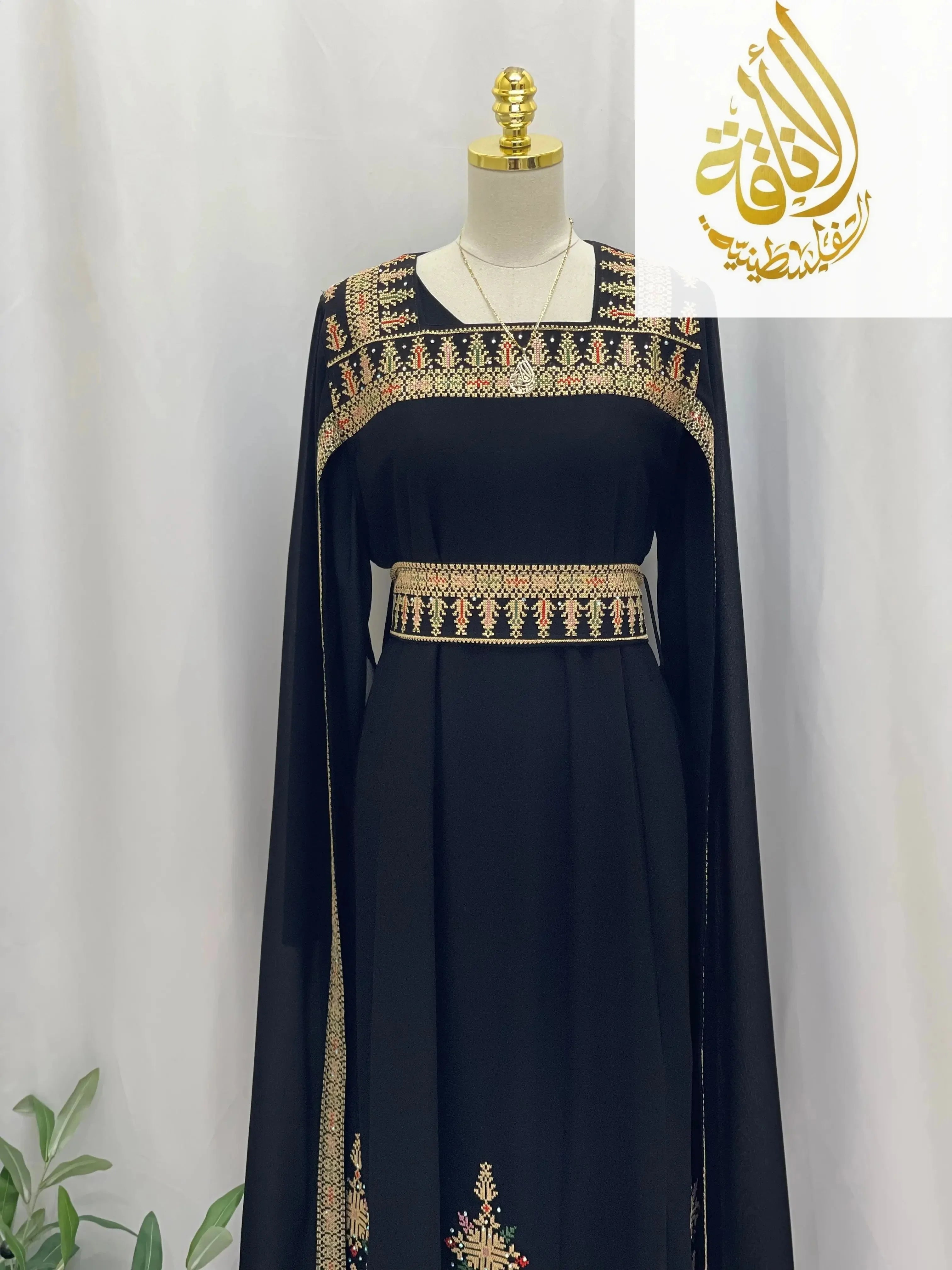 Black embroidered Palestinian dress with intricate beige and red traditional embroidery on neckline, waist, and sleeves