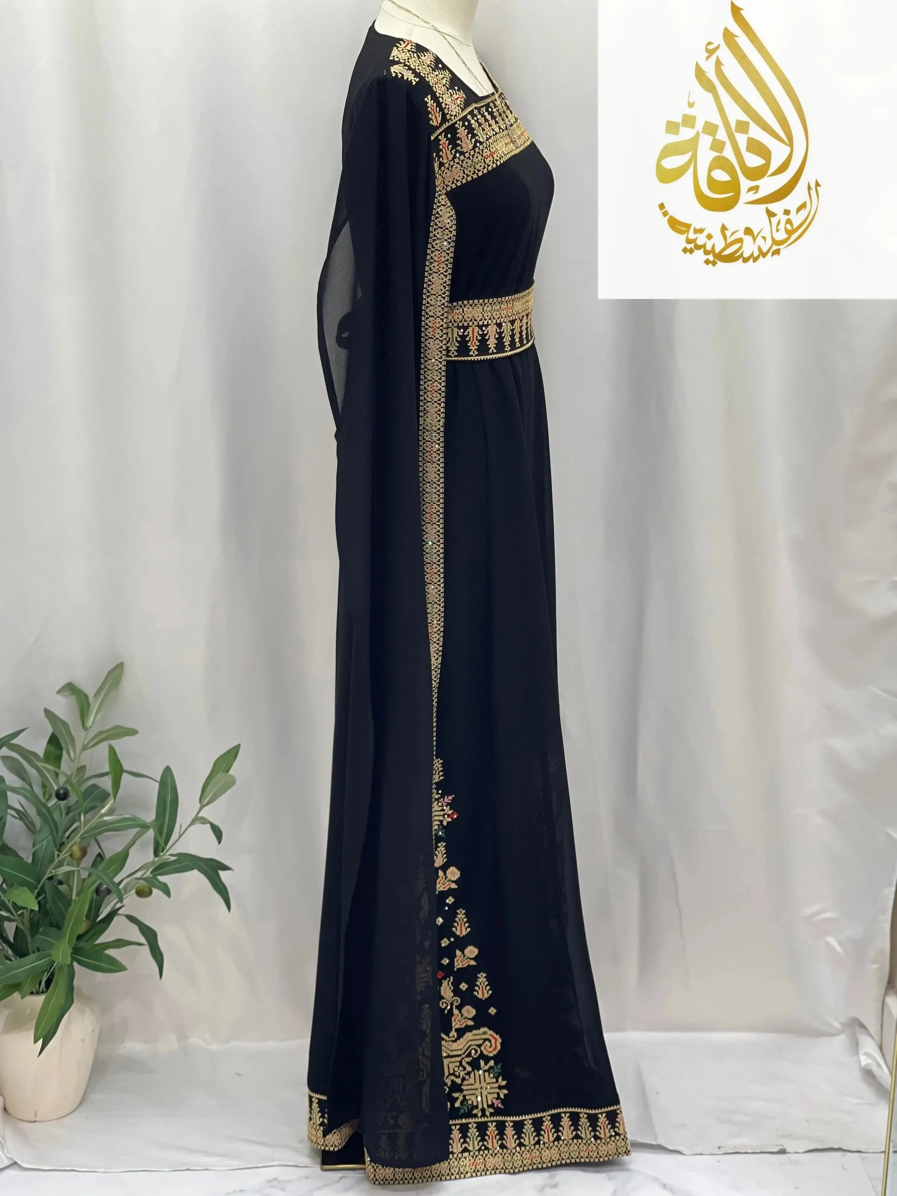 Black embroidered Palestinian dress with gold and colorful traditional embroidery by Palestinian Elegance