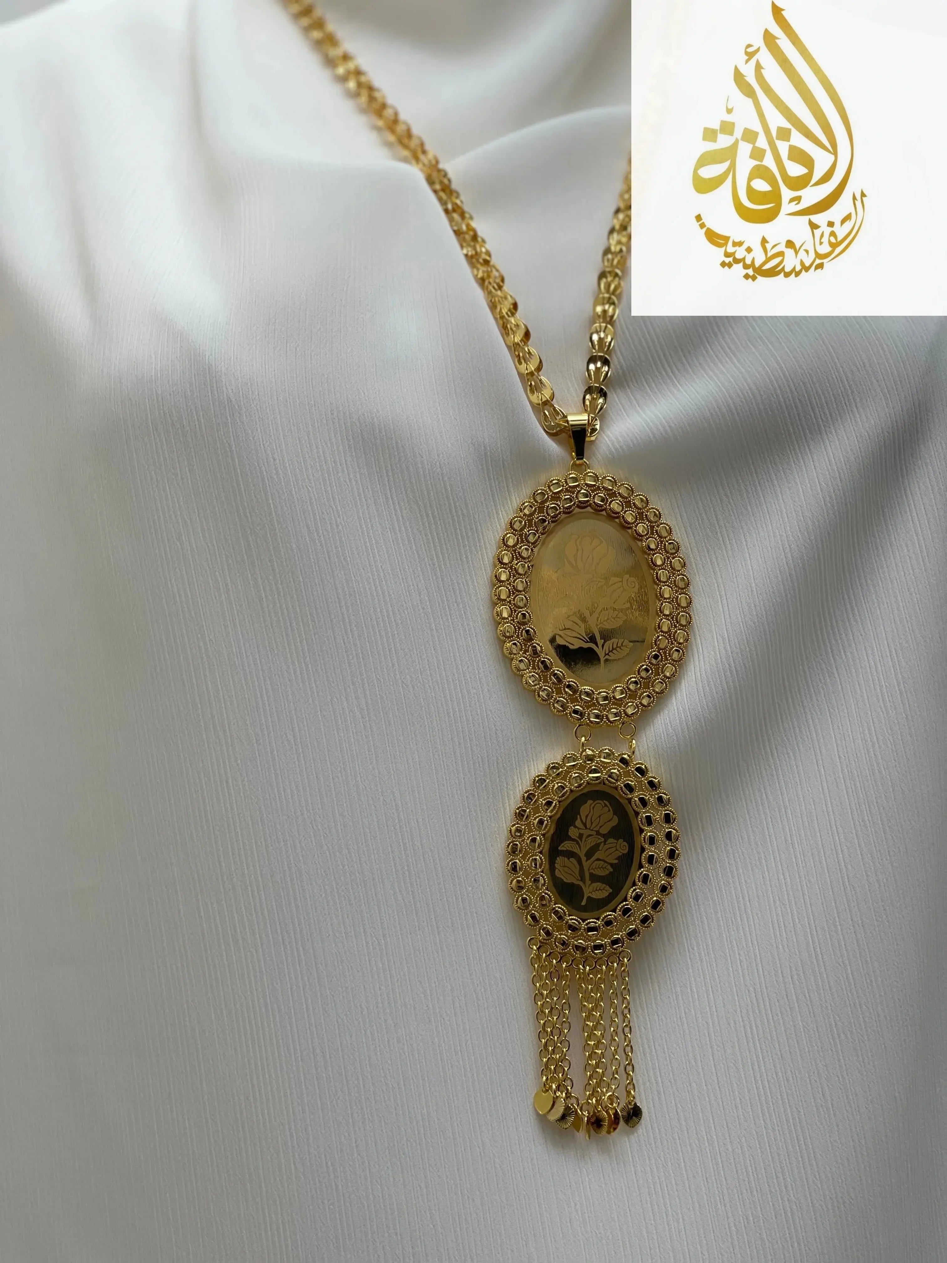 Palestinian Elegance imitated gold oval necklace with intricate floral design and chain tassels