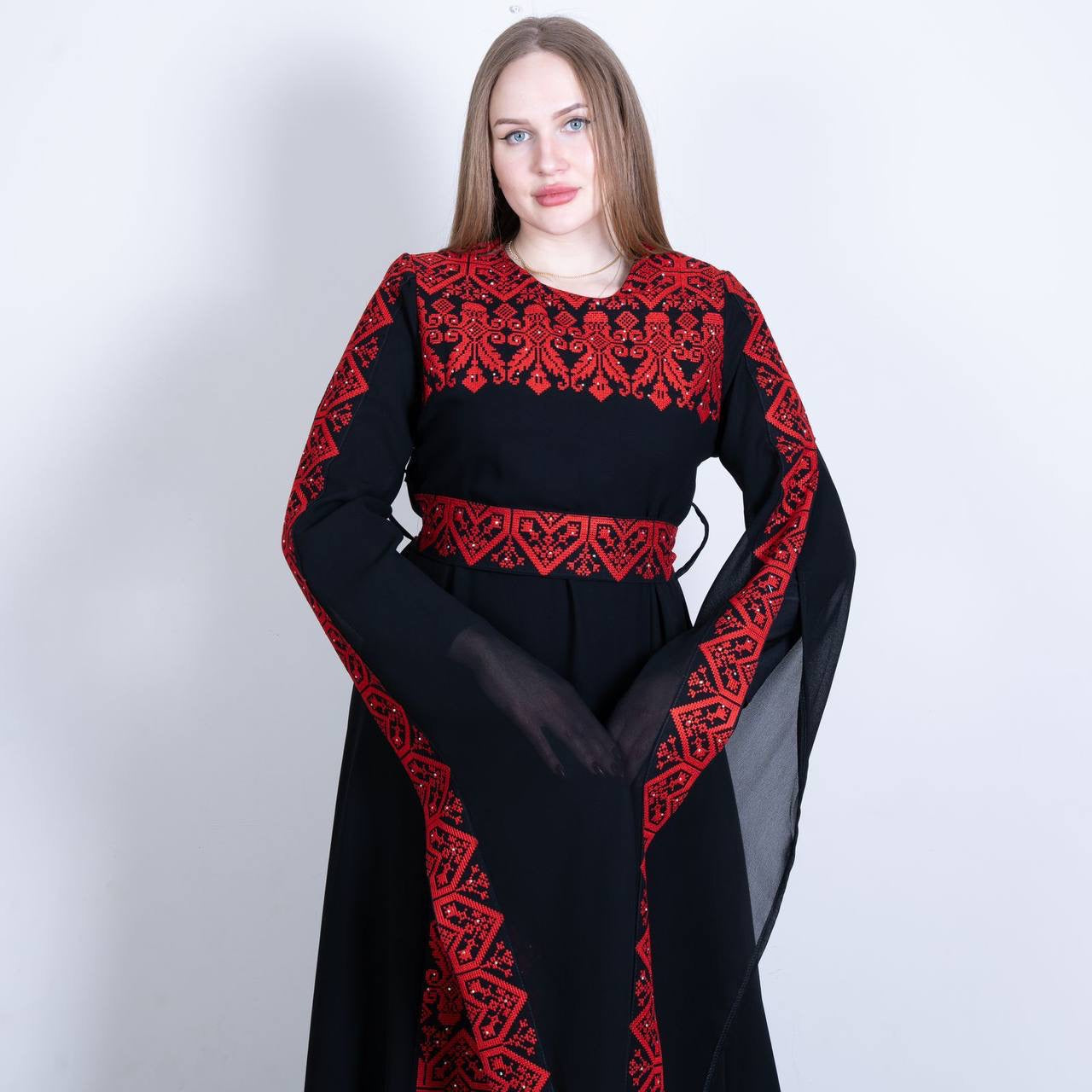 Palestinian embroidered dress by Palestinian Elegance in black with intricate red embroidery on chest, sleeves, and waist