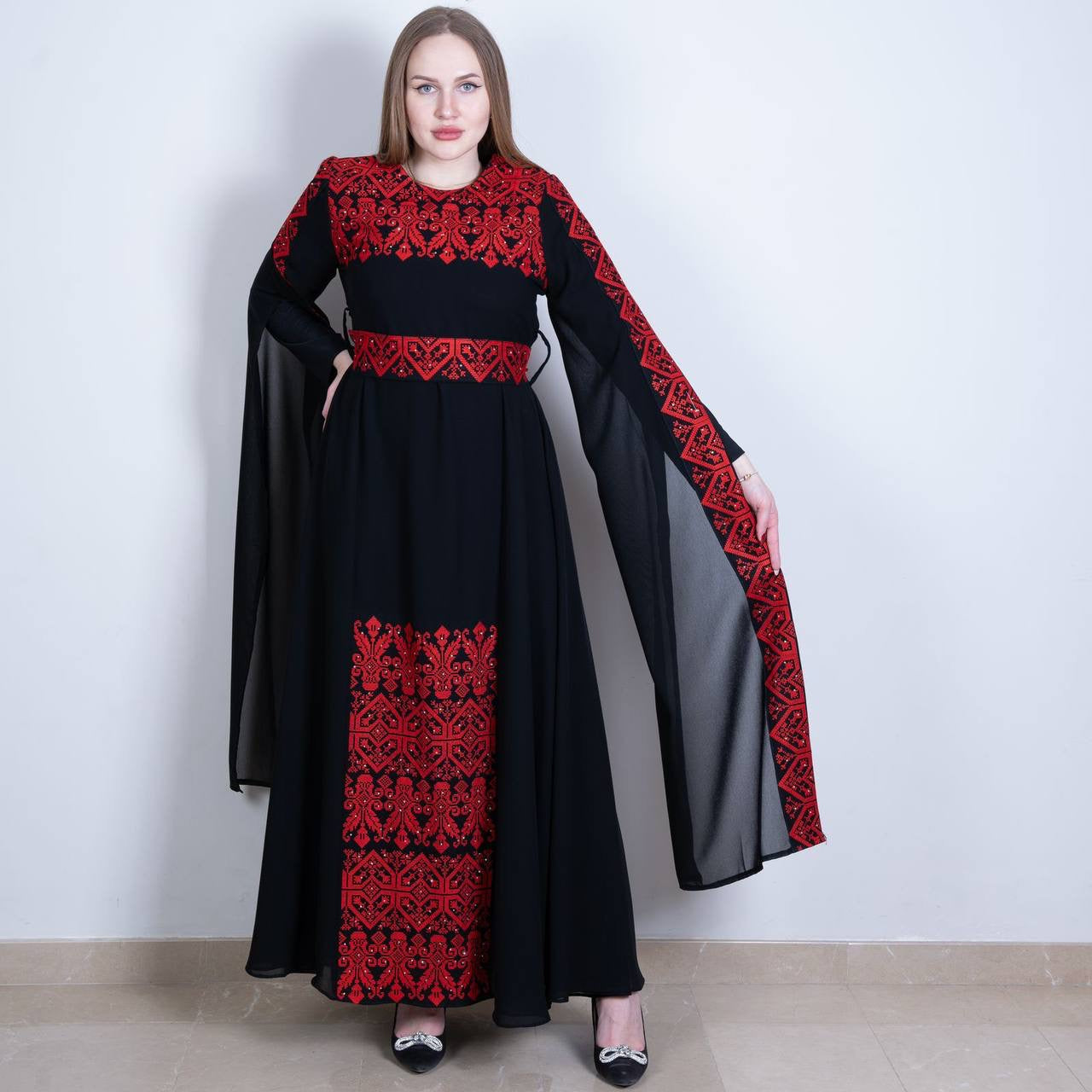 Palestinian embroidered dress in black with red traditional embroidery and flowing sleeves by Palestinian Elegance