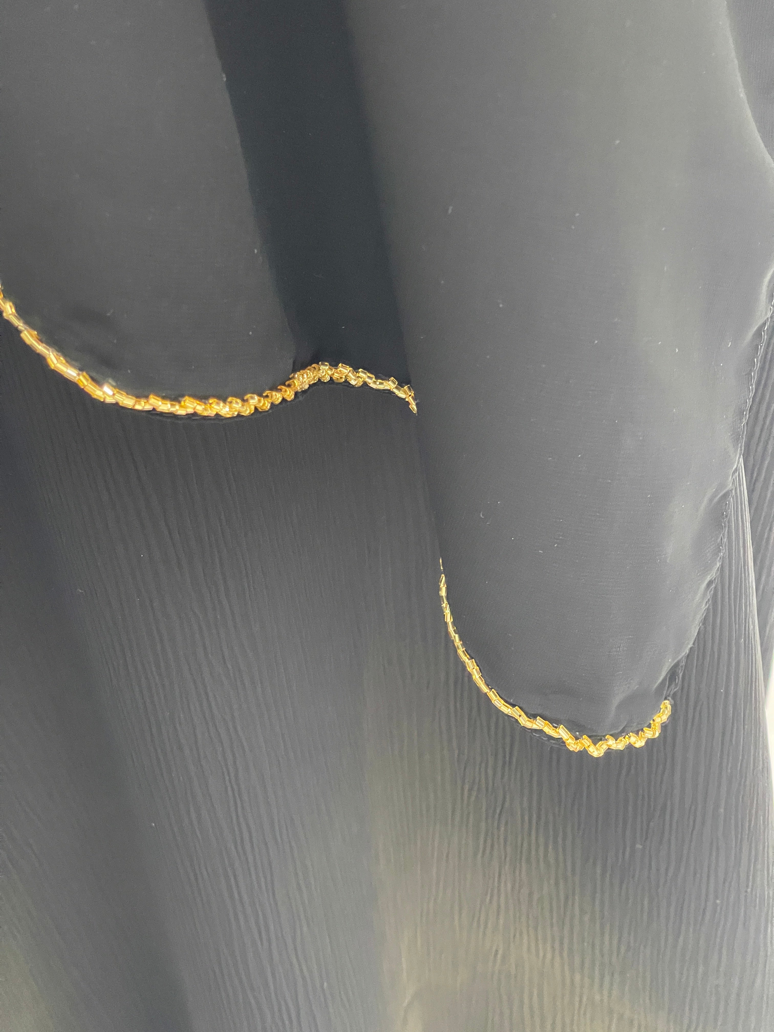 Palestinian Luxury Modest Fashion Abaya in black fabric with intricate gold embroidery detailing