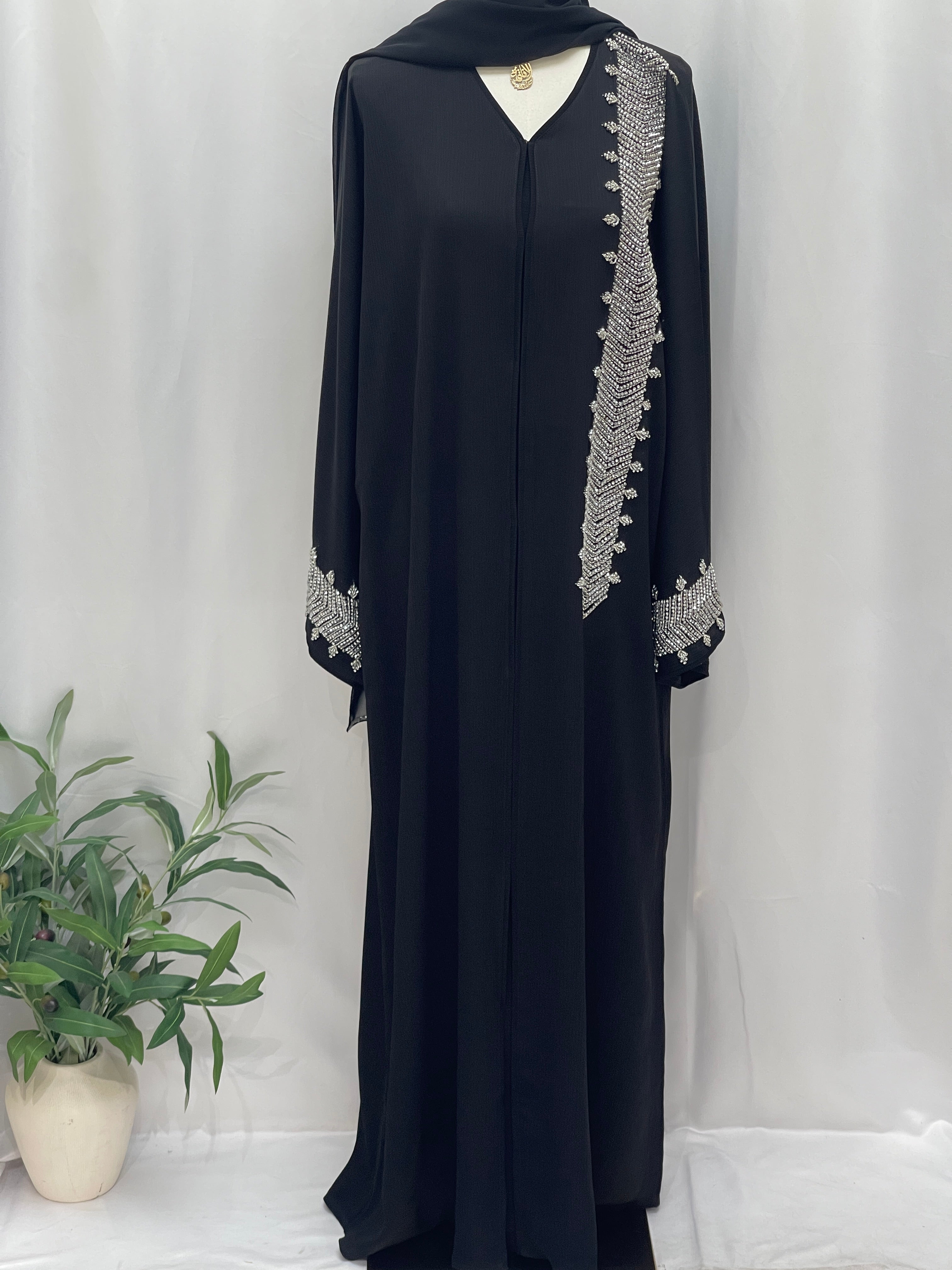 Black Palestinian Luxury Modest Fashion Abaya with intricate silver embroidery on sleeve and chest by Palestinian Elegance