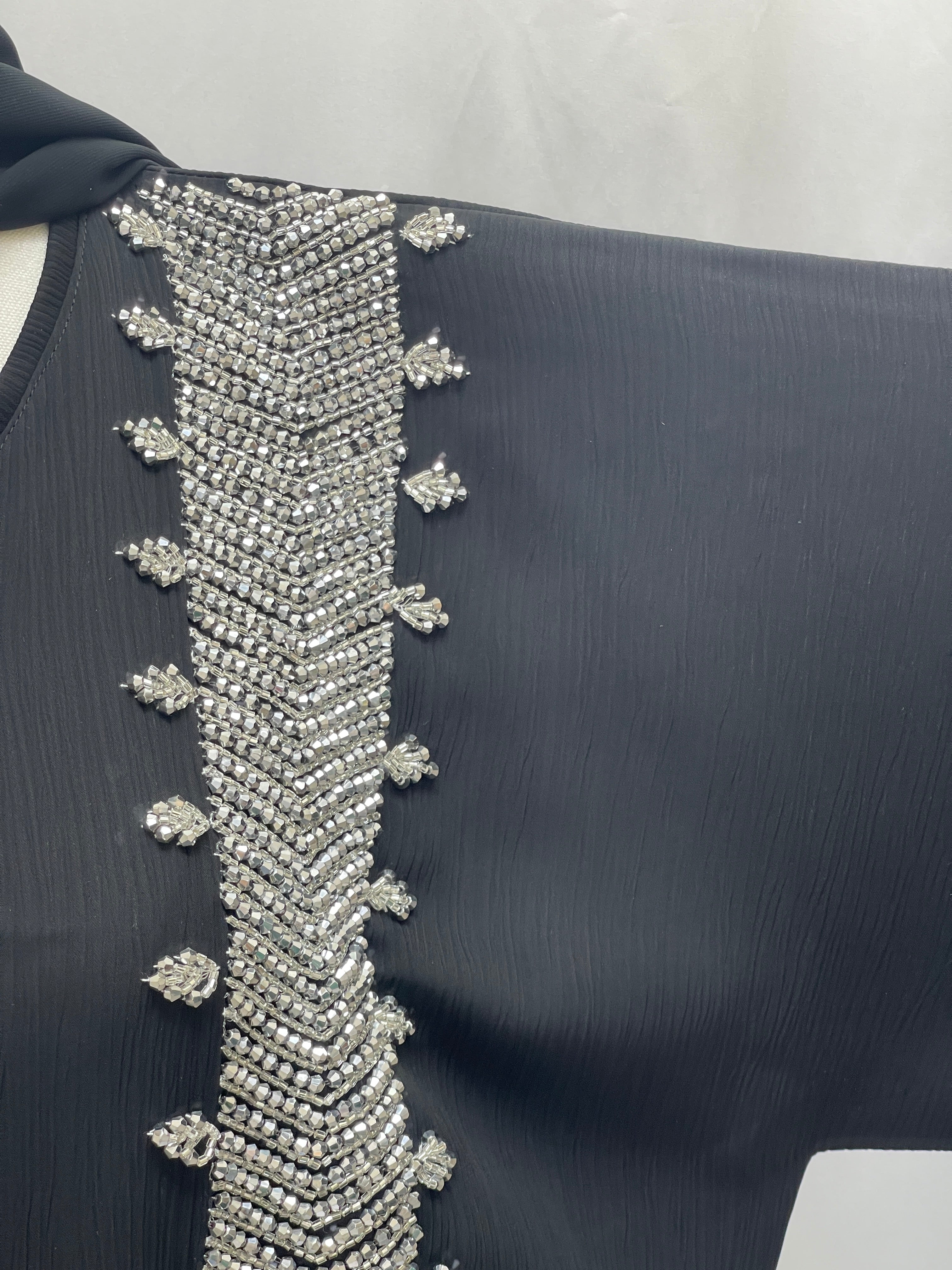 Black Palestinian Luxury Modest Fashion Abaya with intricate silver bead embroidery detail on the sleeve