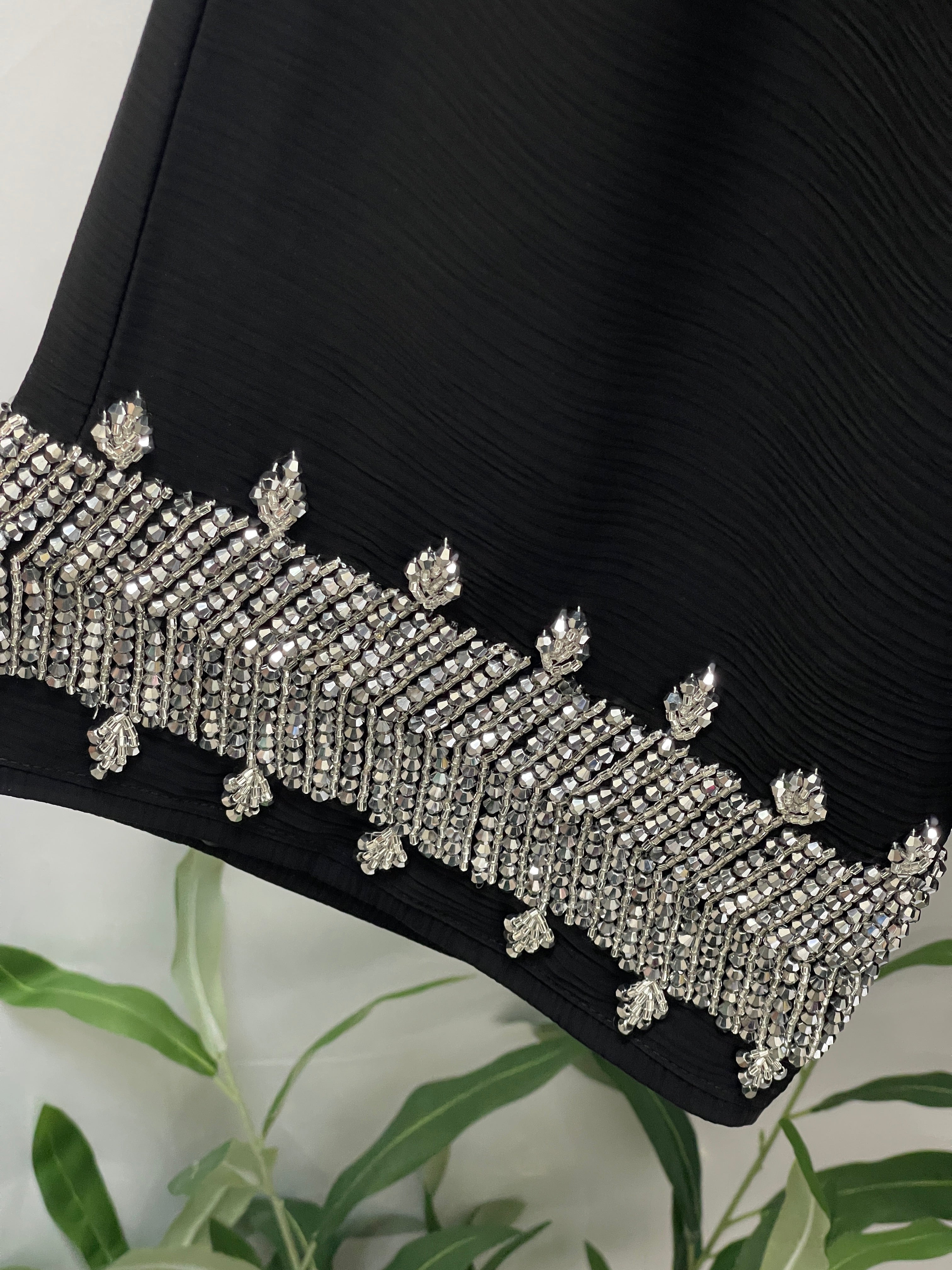 Black Palestinian Luxury Modest Fashion Abaya with intricate silver bead embellishments on the hem by Palestinian Elegance