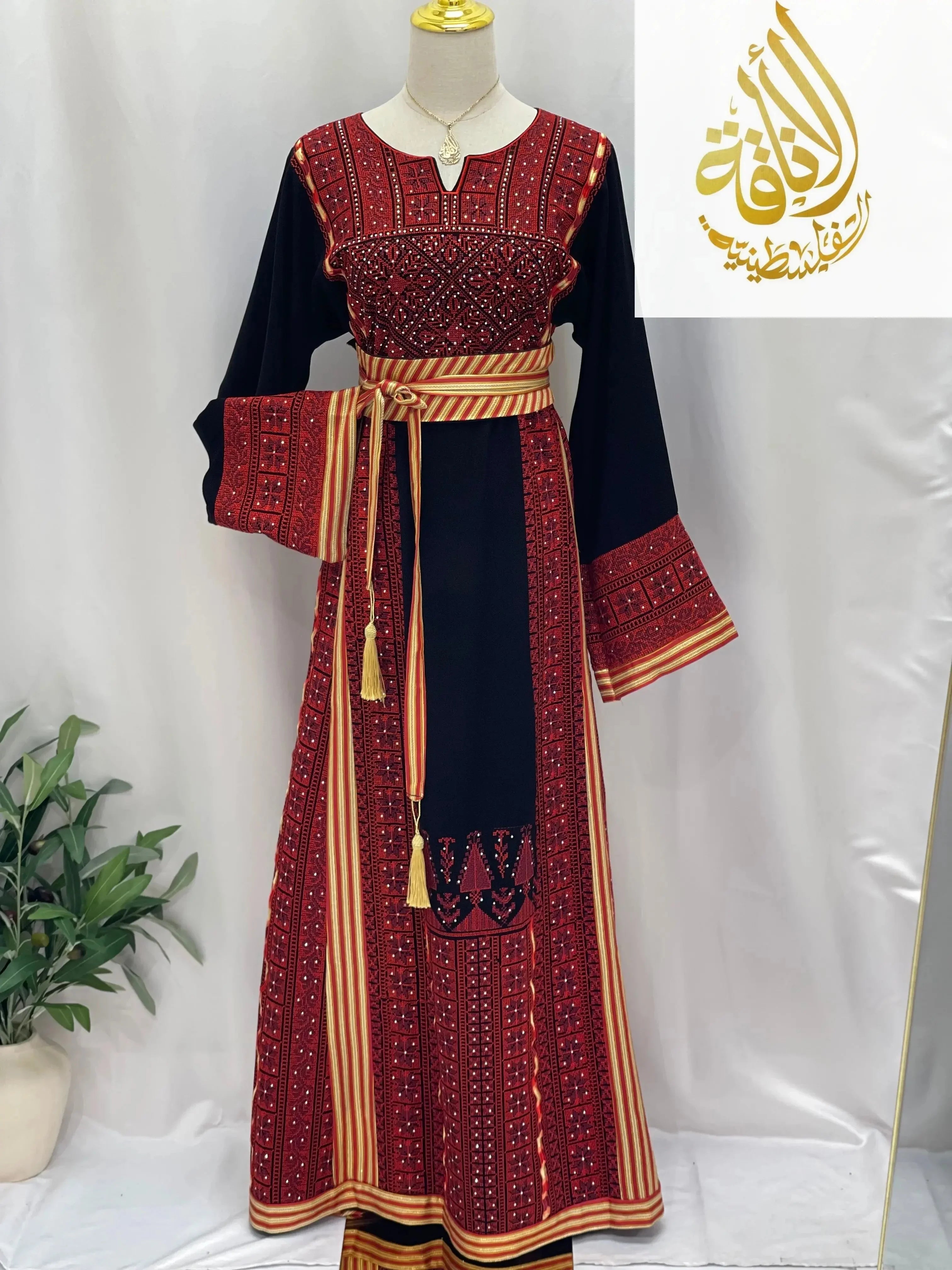 Embroidered Palestinian thoub dress by Palestinian Elegance with intricate red and black traditional patterns