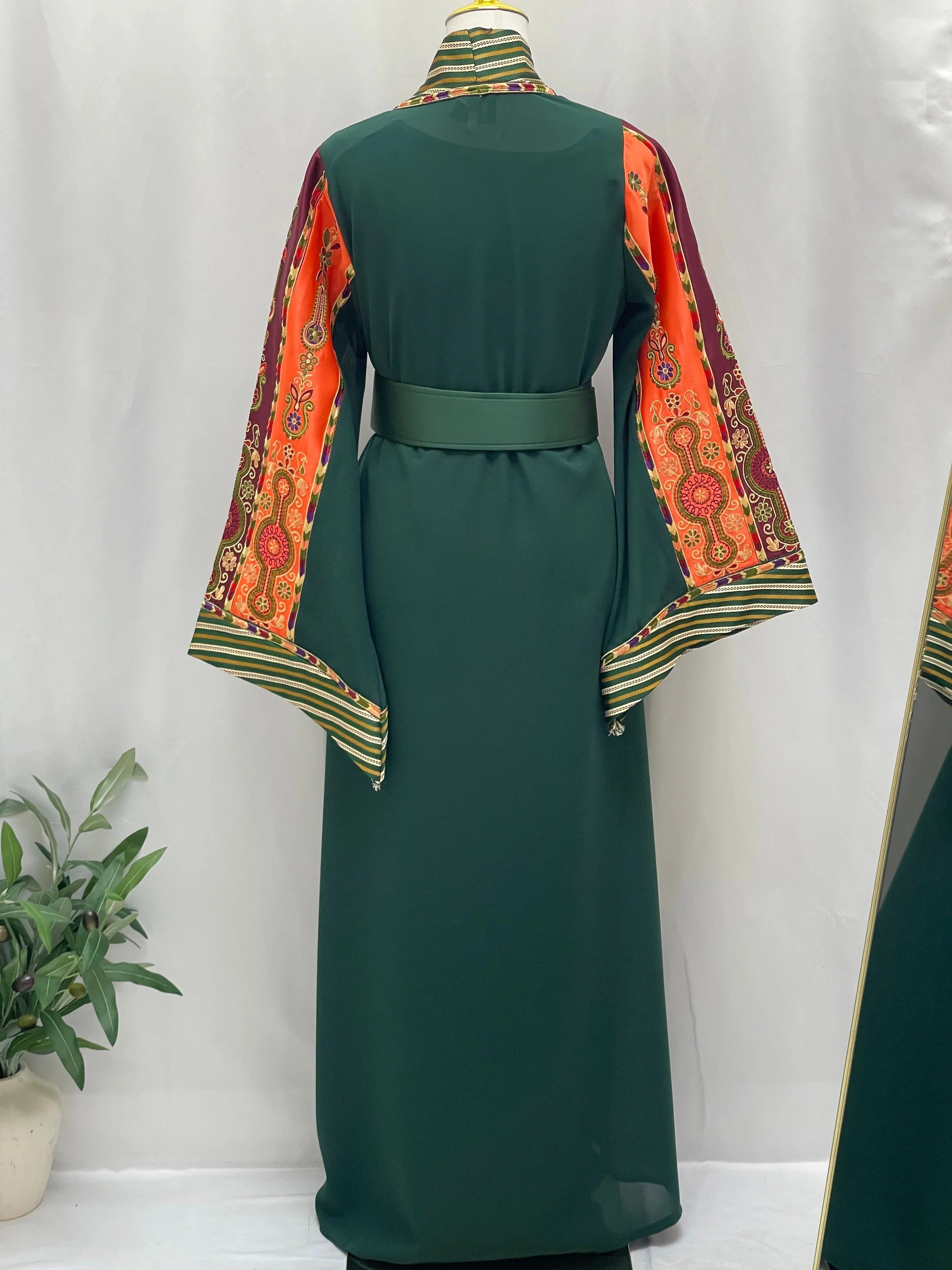 Palestinian Elegance green cardigan featuring elegant modest fashion bisht with colorful patterned sleeves and waist belt