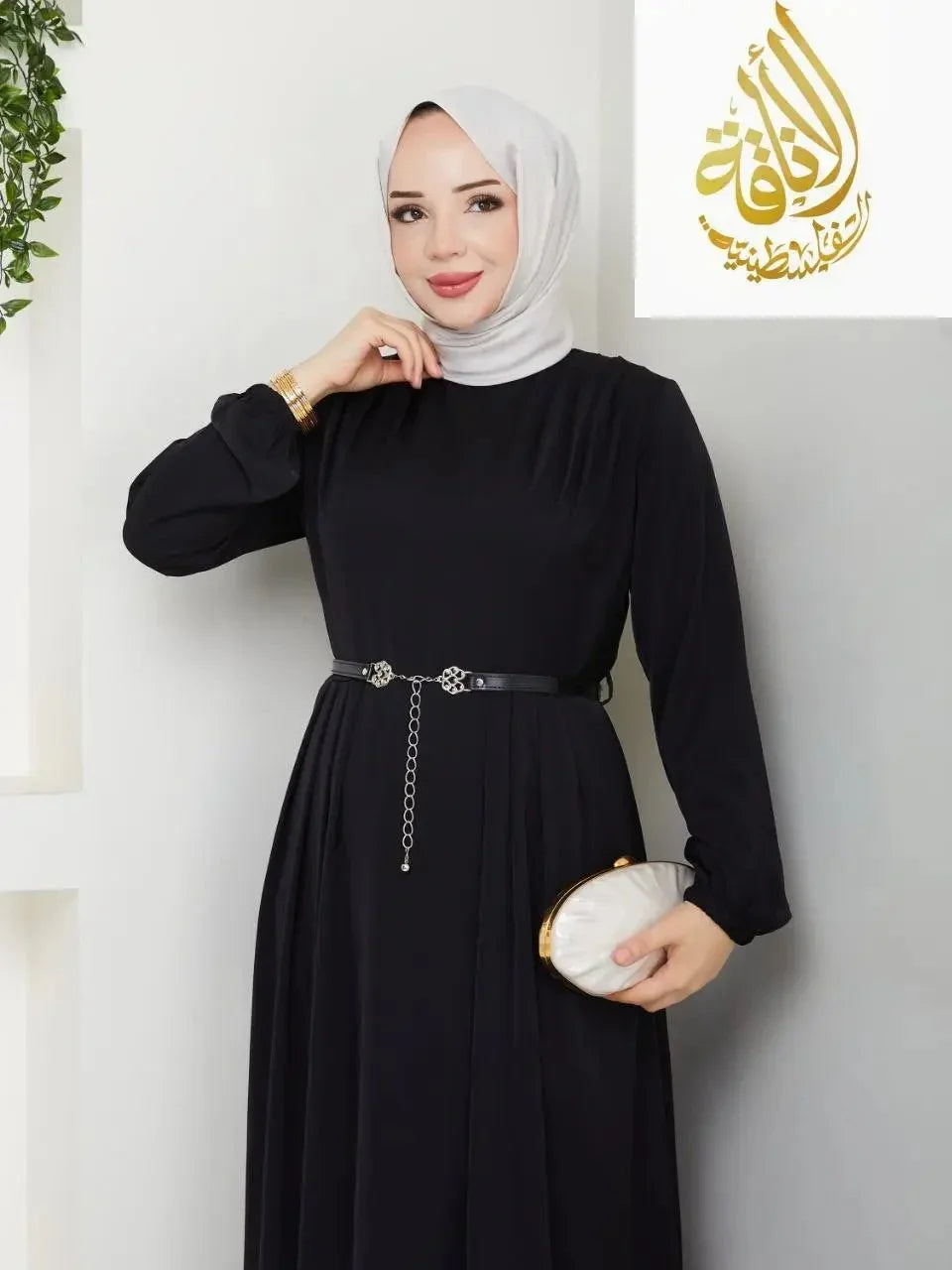 Elegant long dress for special occasions by Palestinian Elegance in black with a belt and modest design