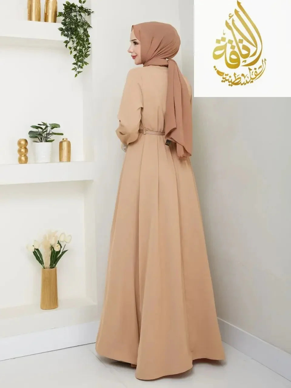 Elegant long dress for special occasions in beige worn with a matching hijab by Palestinian Elegance
