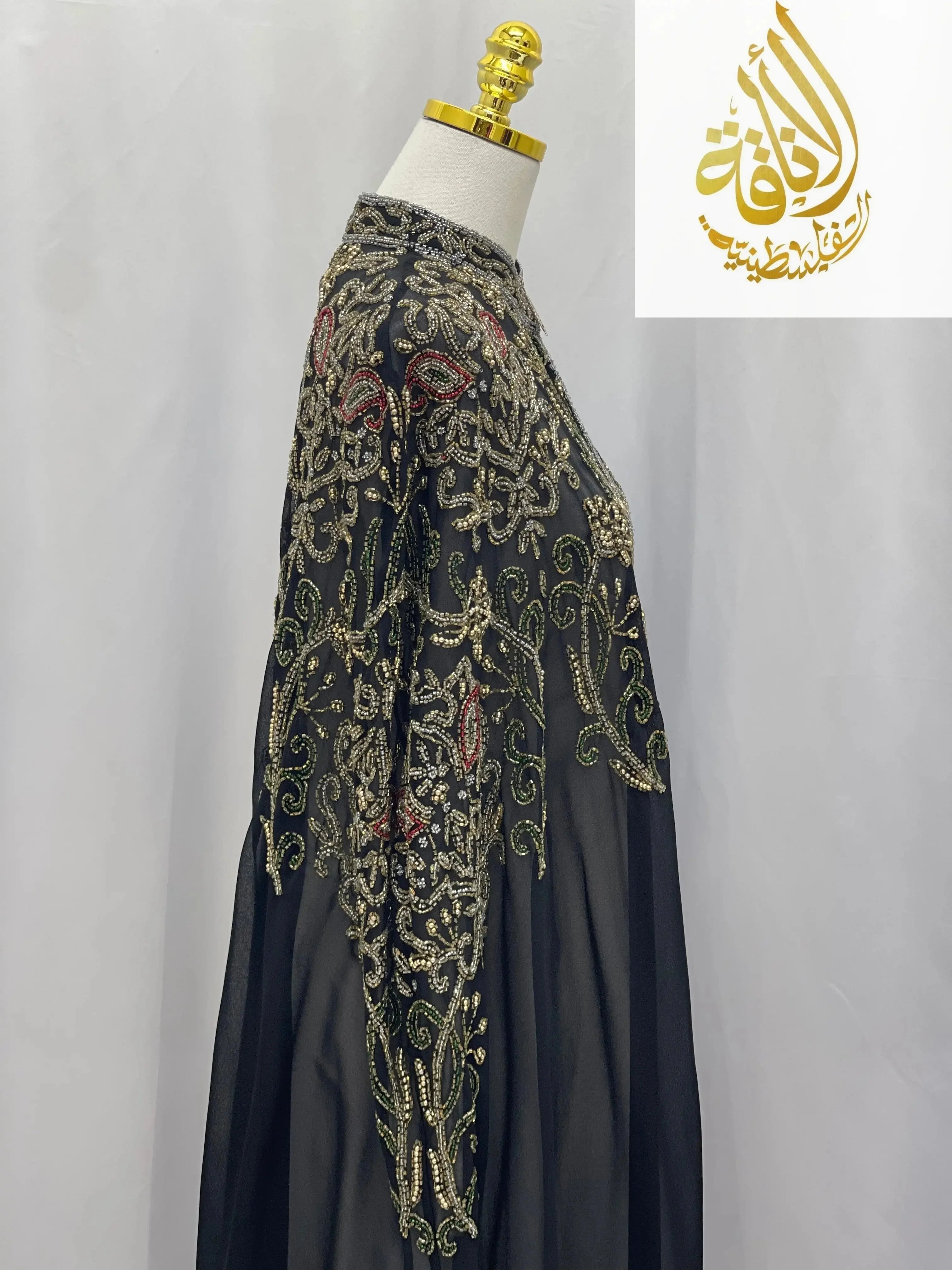 Palestinian Elegance black cardigan with intricate gold embroidery showcasing an elegant modest fashion cape design
