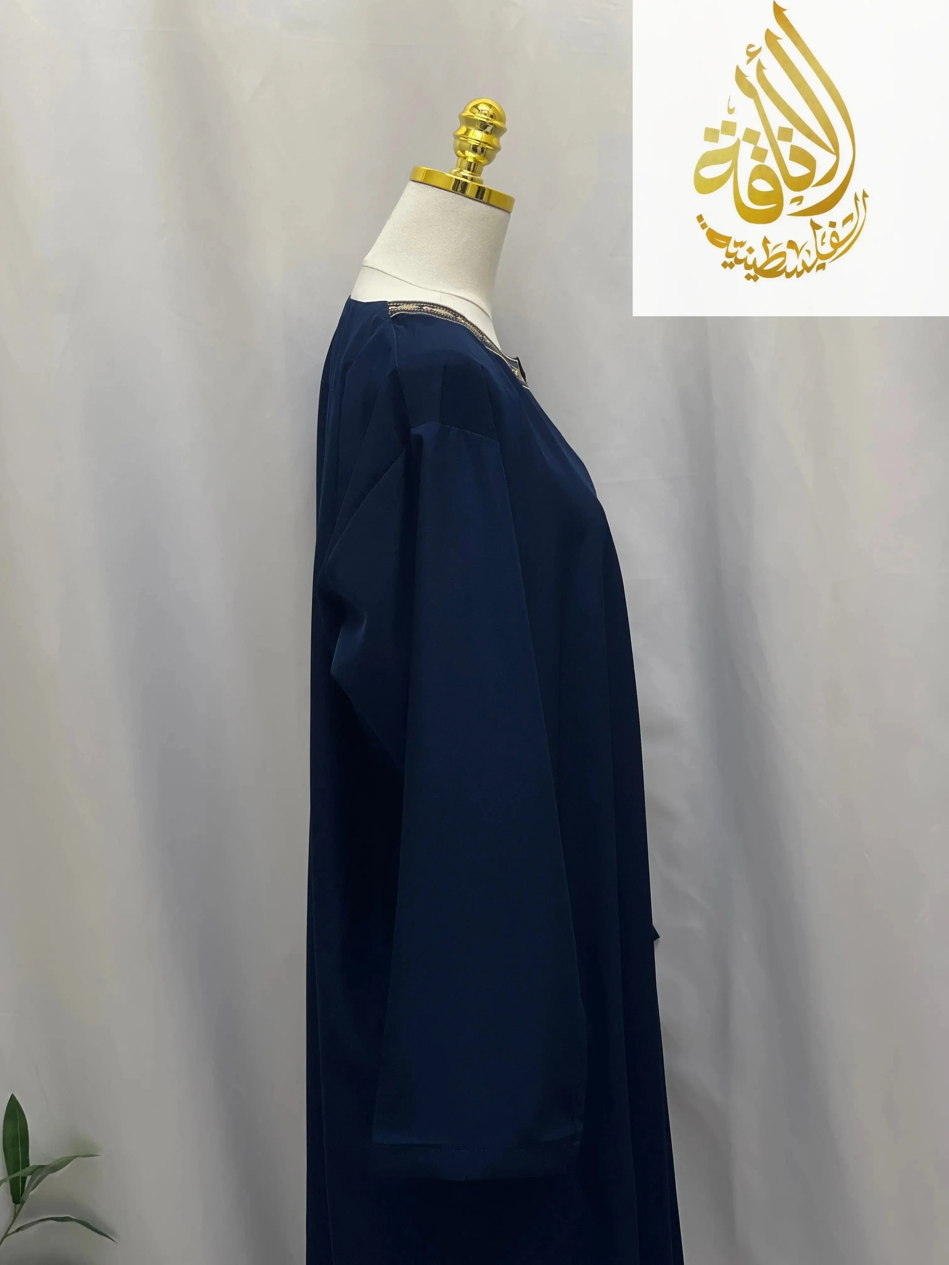 Palestinian Elegance men embroidered thobe dress in navy blue displayed on a mannequin side view