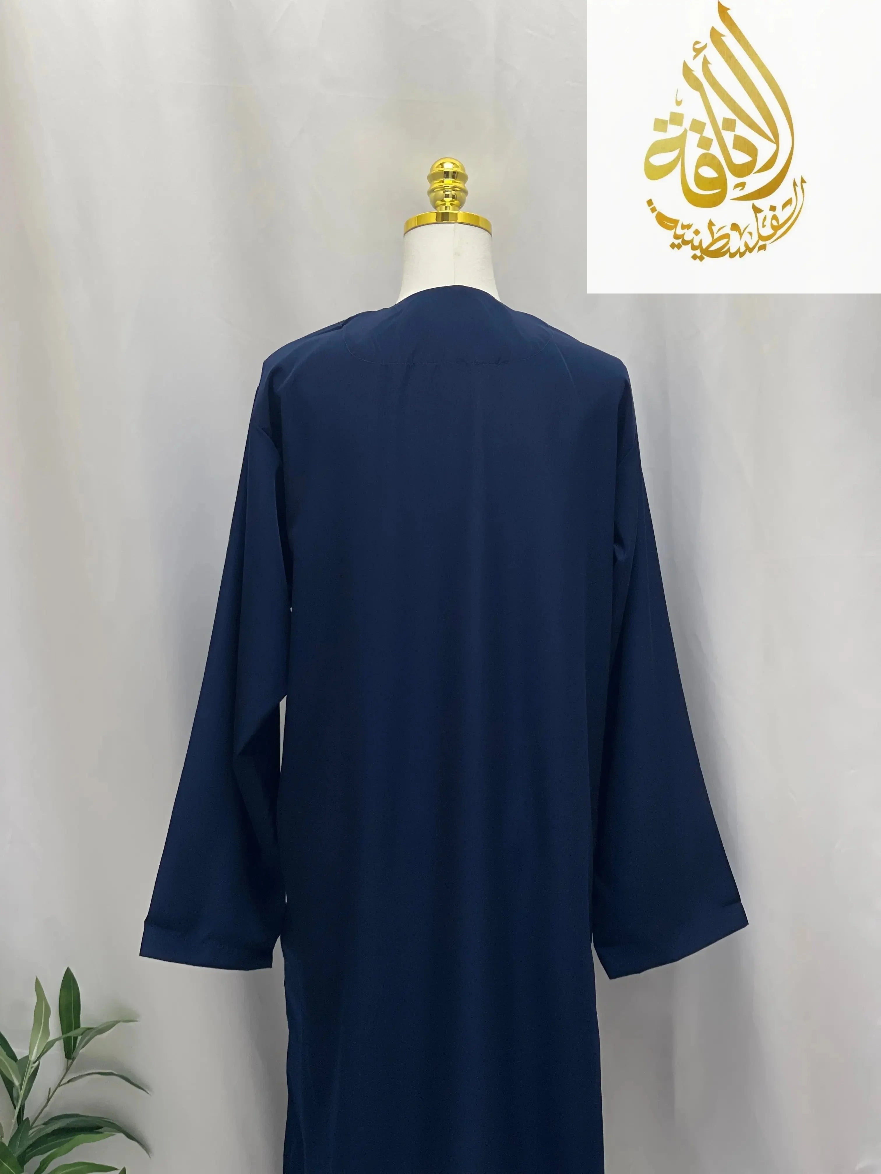 Back view of navy blue embroidered thobe dress for men by Palestinian Elegance on mannequin