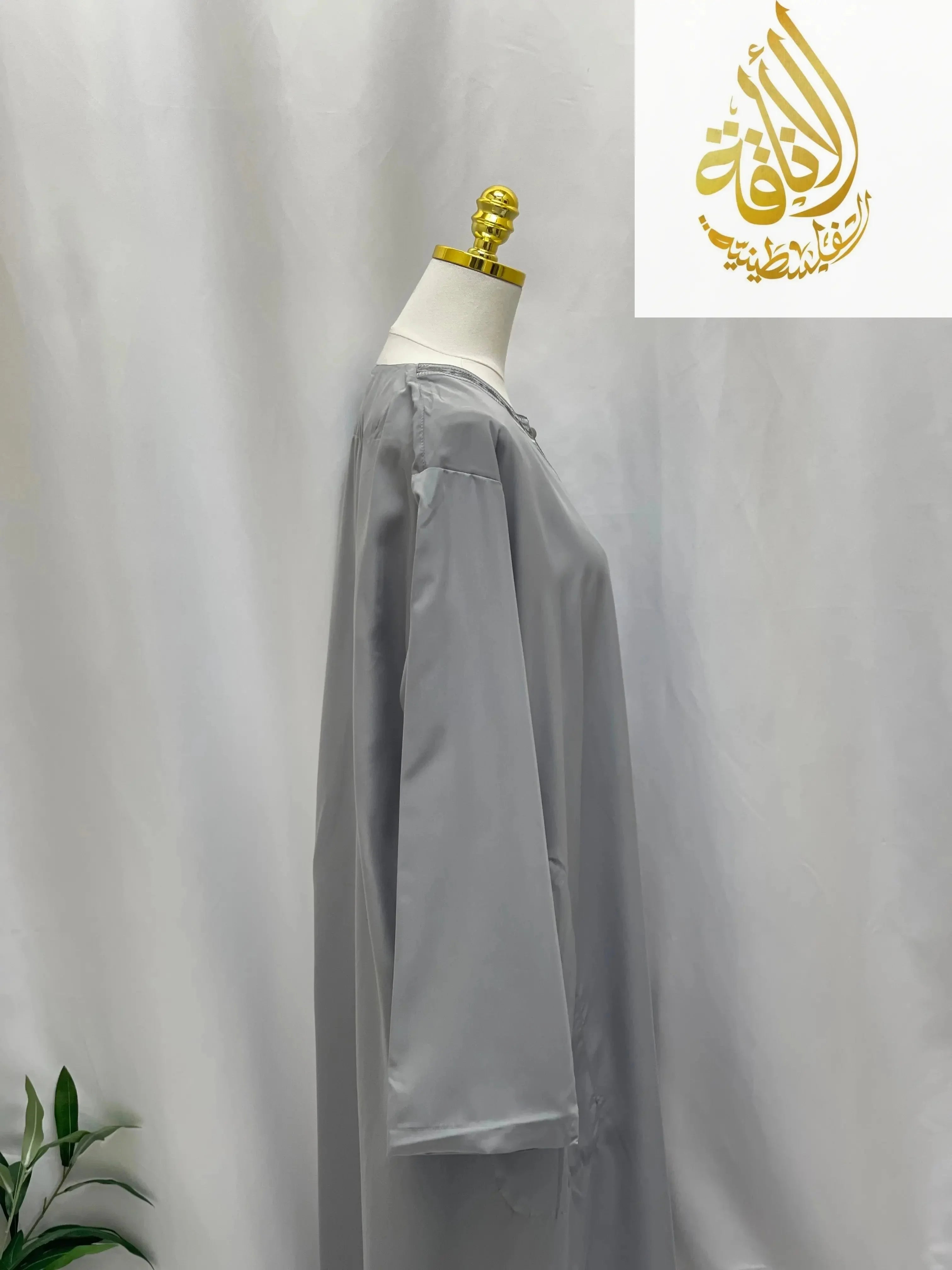 Palestinian Elegance gray men thobe featuring traditional embroidered thobe dress details on mannequin