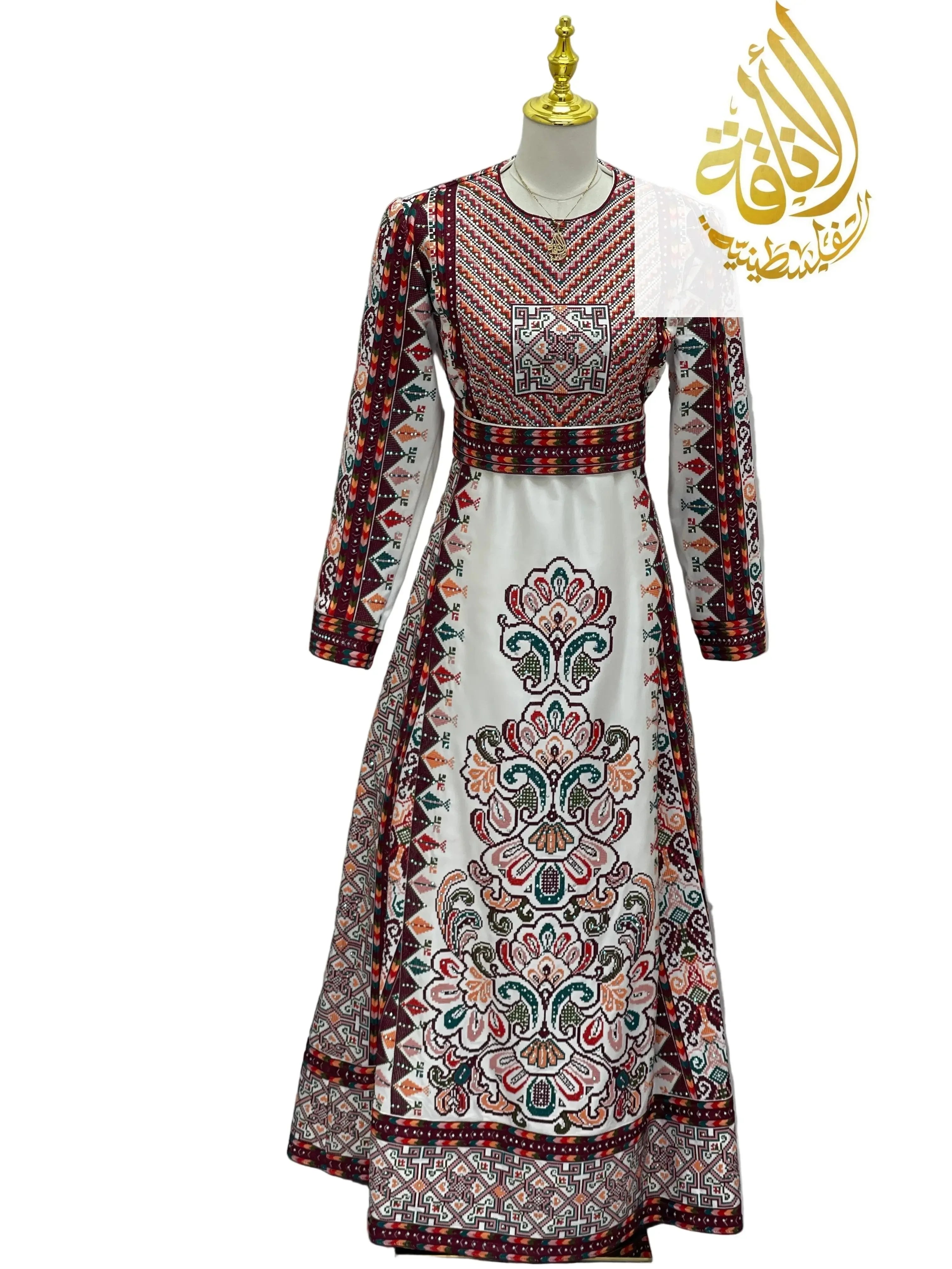 White Palestinian bridal thoub with intricate colorful embroidery displayed on mannequin by Palestinian Elegance