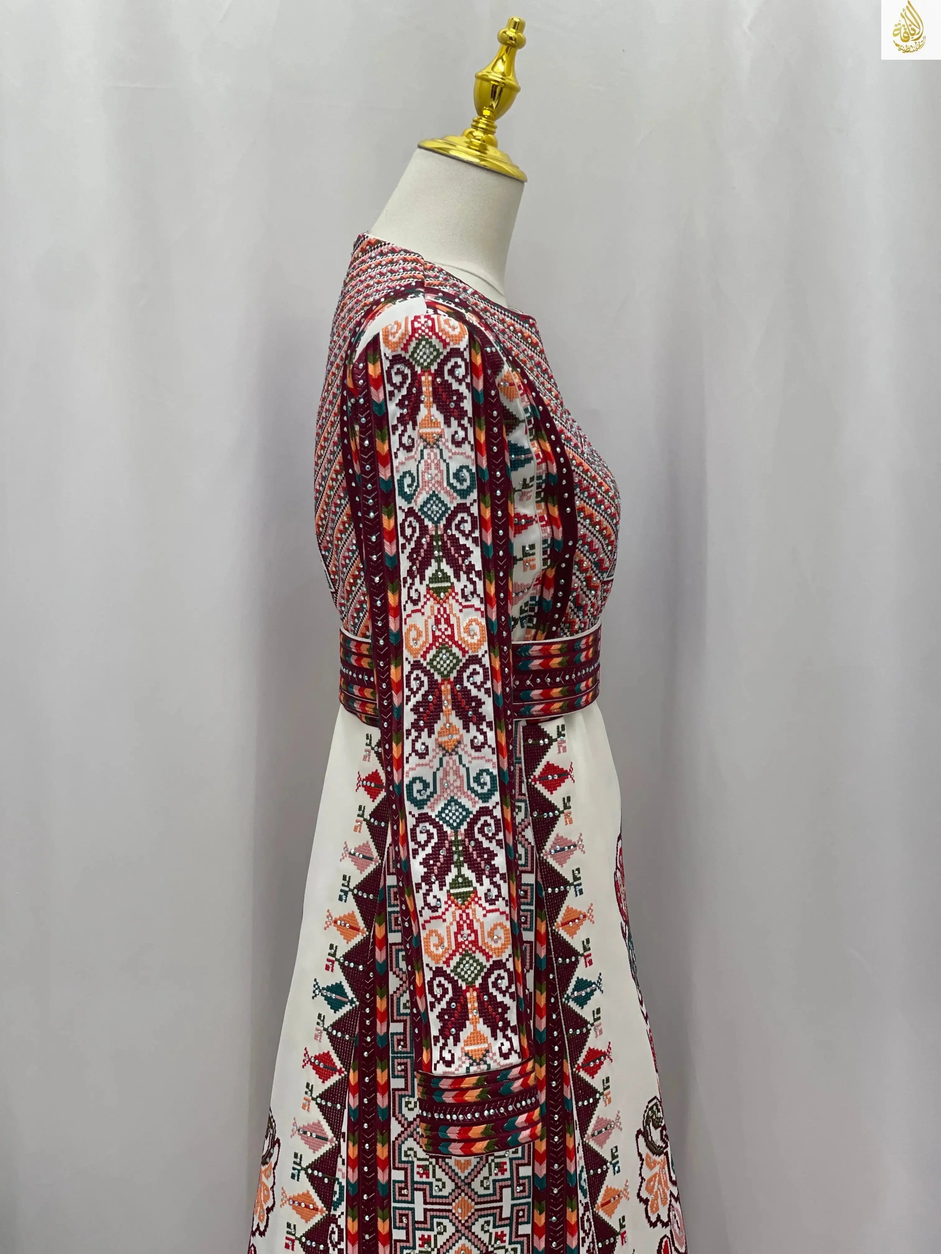 Side view of a white Palestinian bridal thoub with colorful traditional embroidery by Palestinian Elegance