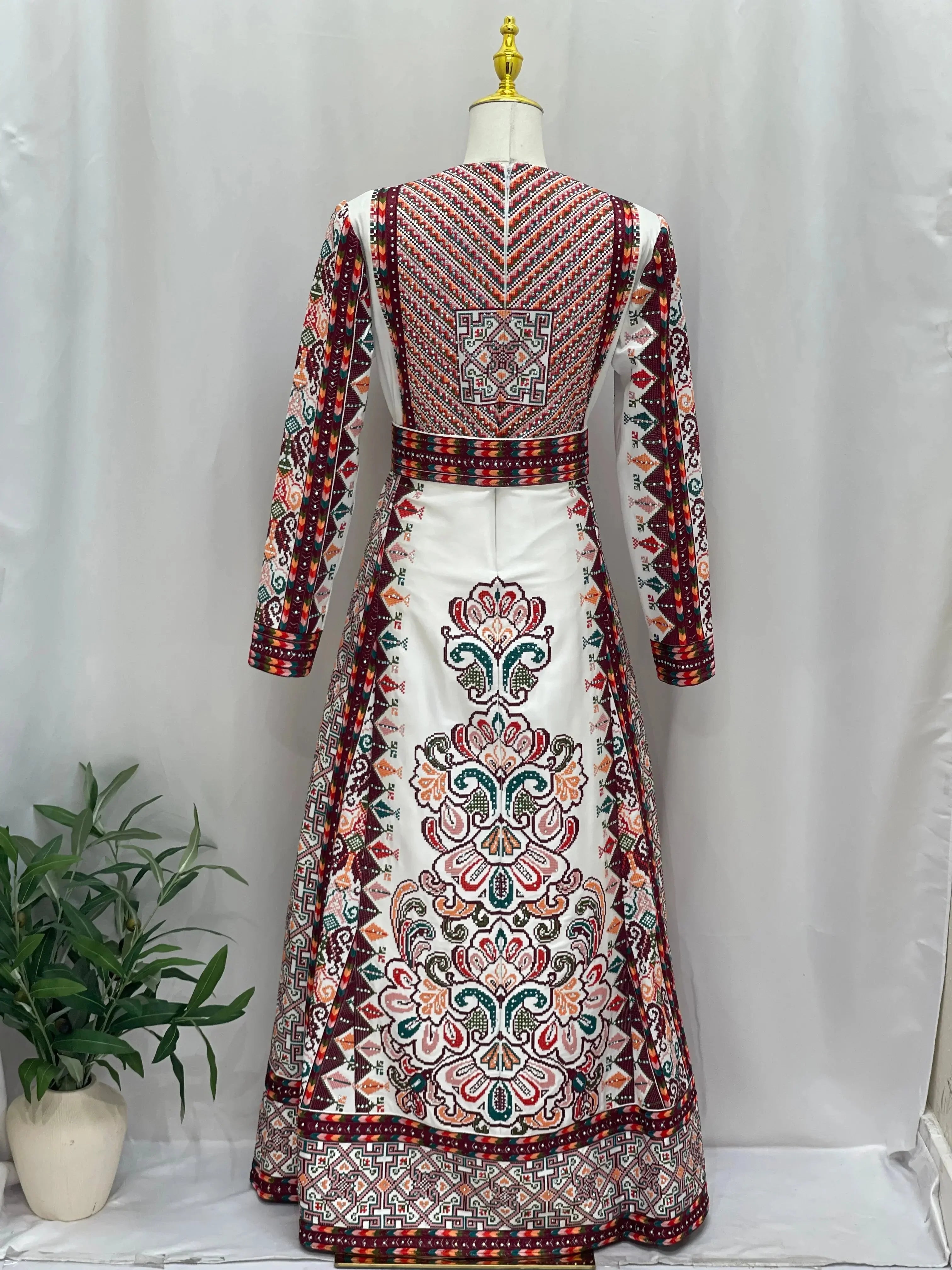 White Palestinian bridal thoub with intricate traditional embroidery and long sleeves by Palestinian Elegance