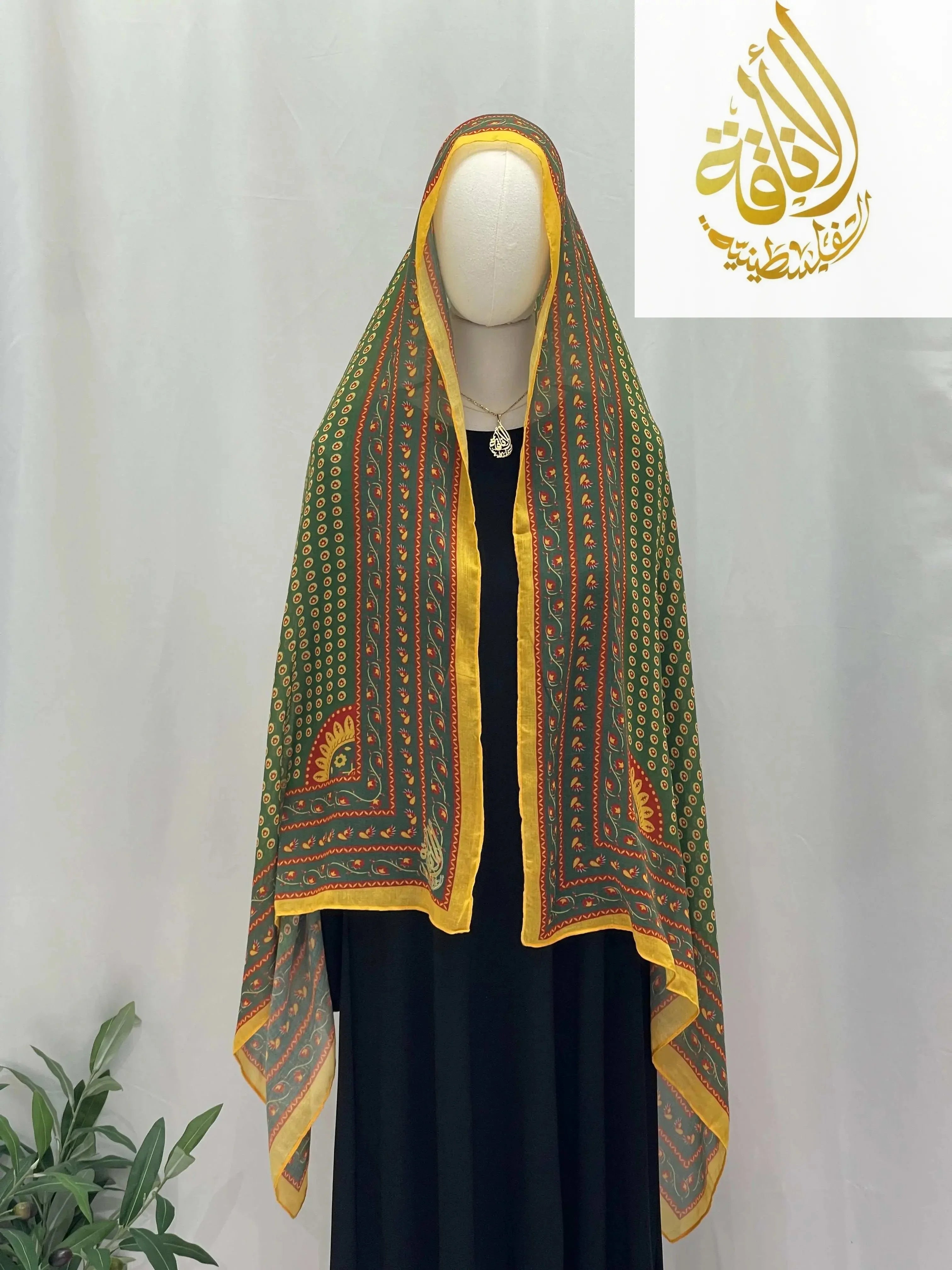 Long Siti Asba Hijab by Palestinian Elegance featuring intricate green and yellow patterned design