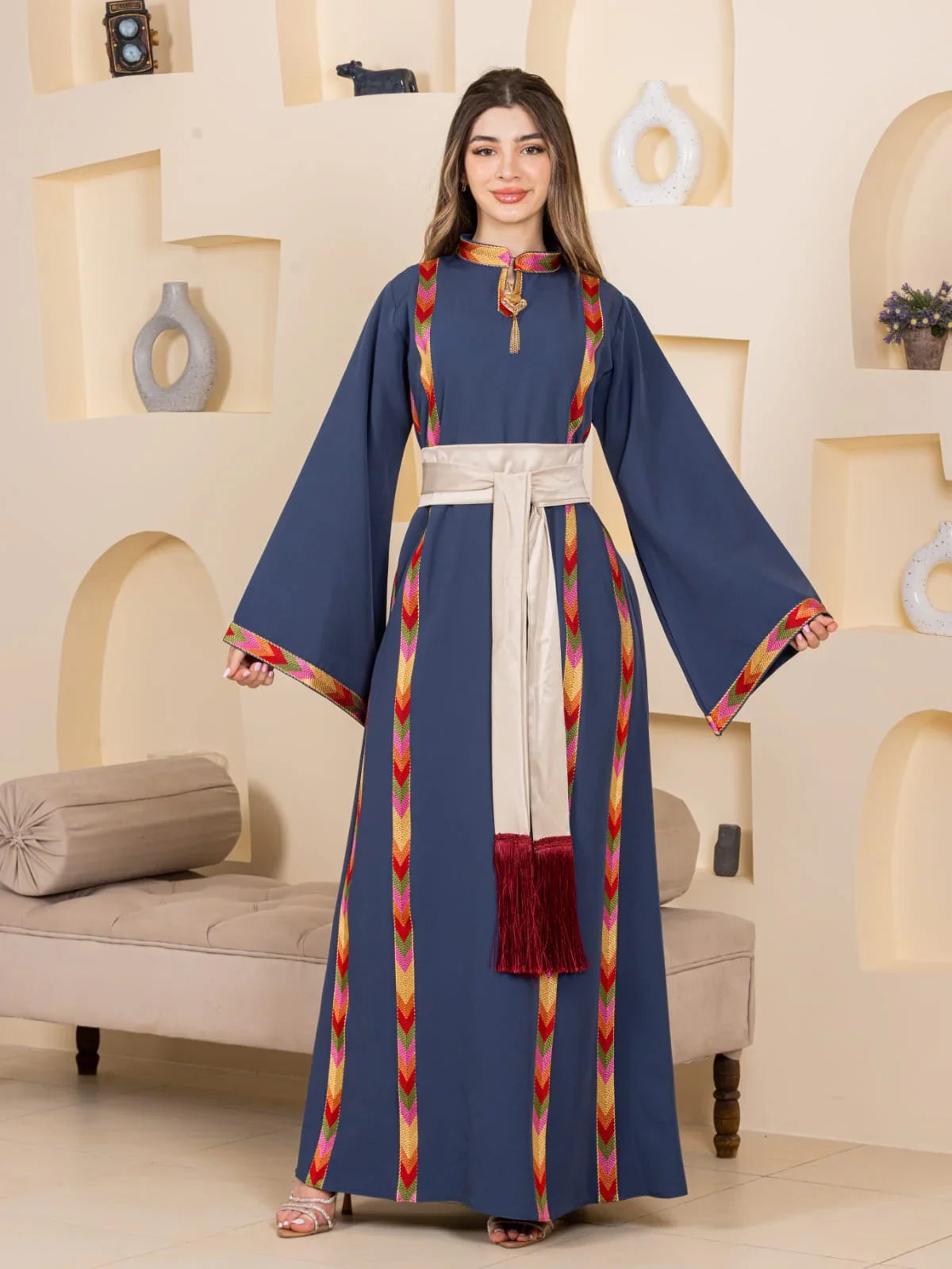 Embroiderd Thoub Al-Manajel navy embroidered Palestinian thobe with multicolor chevron trim beige waist sash and red tassel