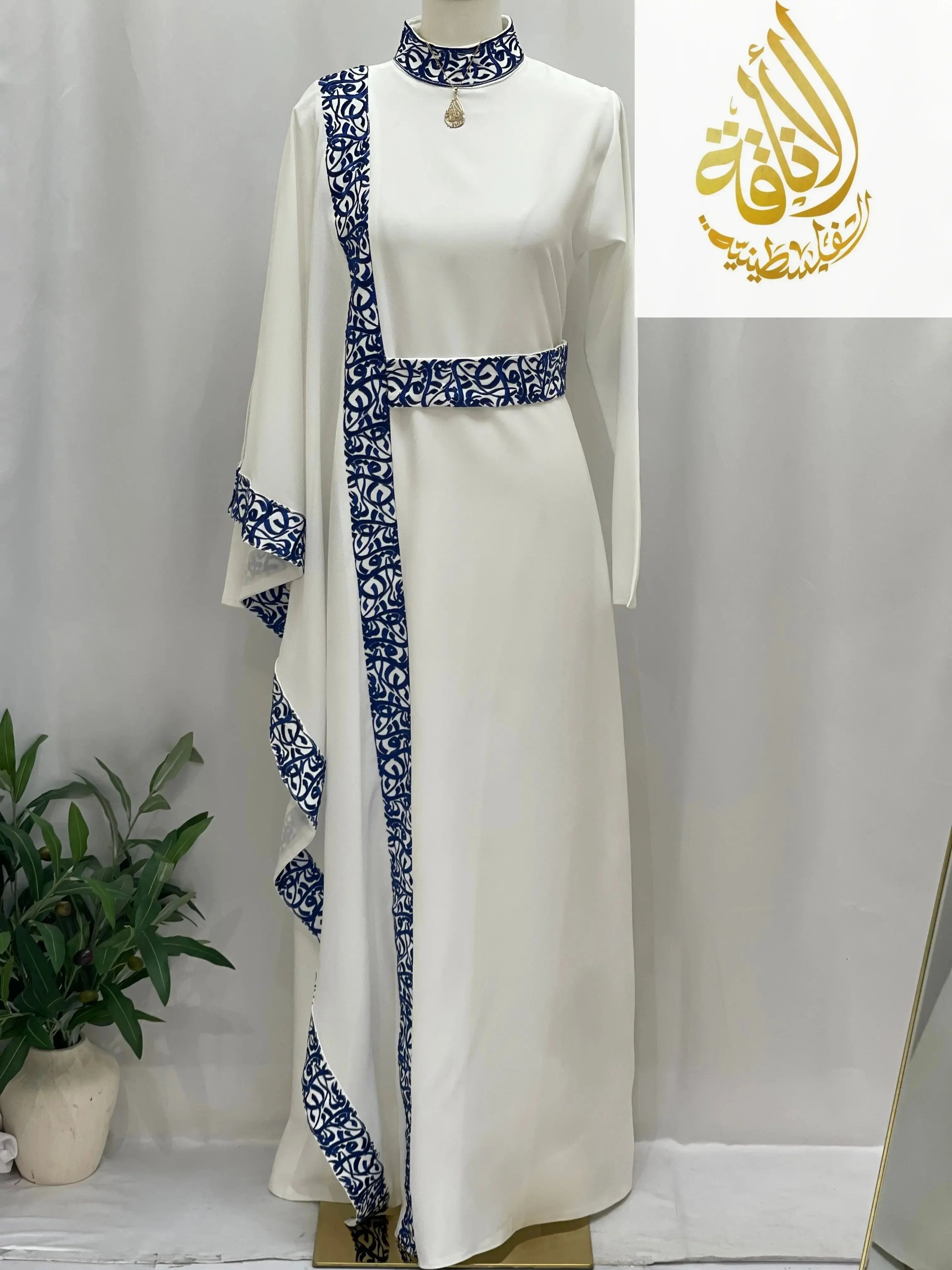 Palestinian Elegance white embroidered abaya with Arabic letters and blue intricate patterns on sleeves and collar