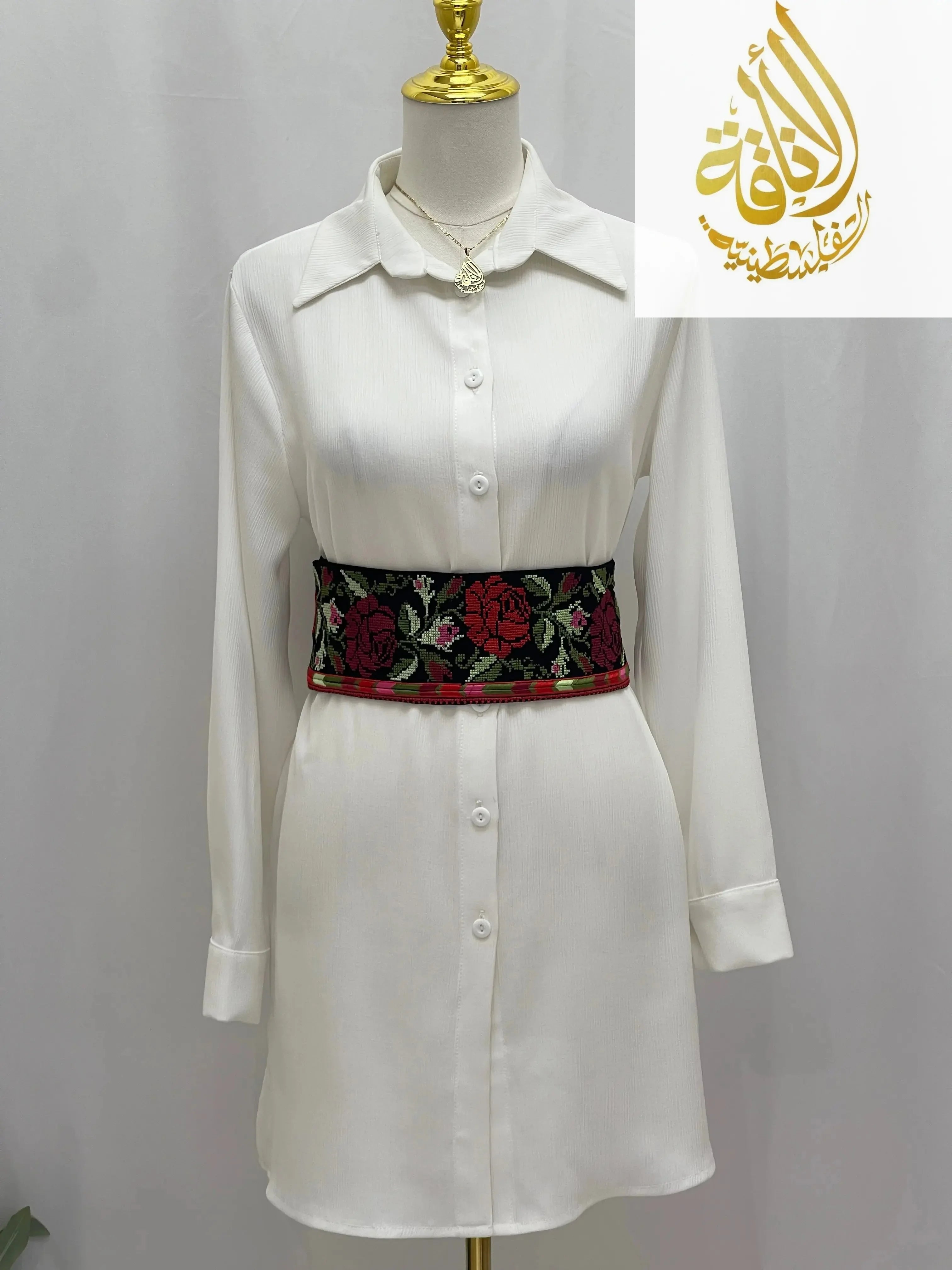 Palestinian Elegance Embroidered Heritage Belt with red and green floral design worn over white shirt dress