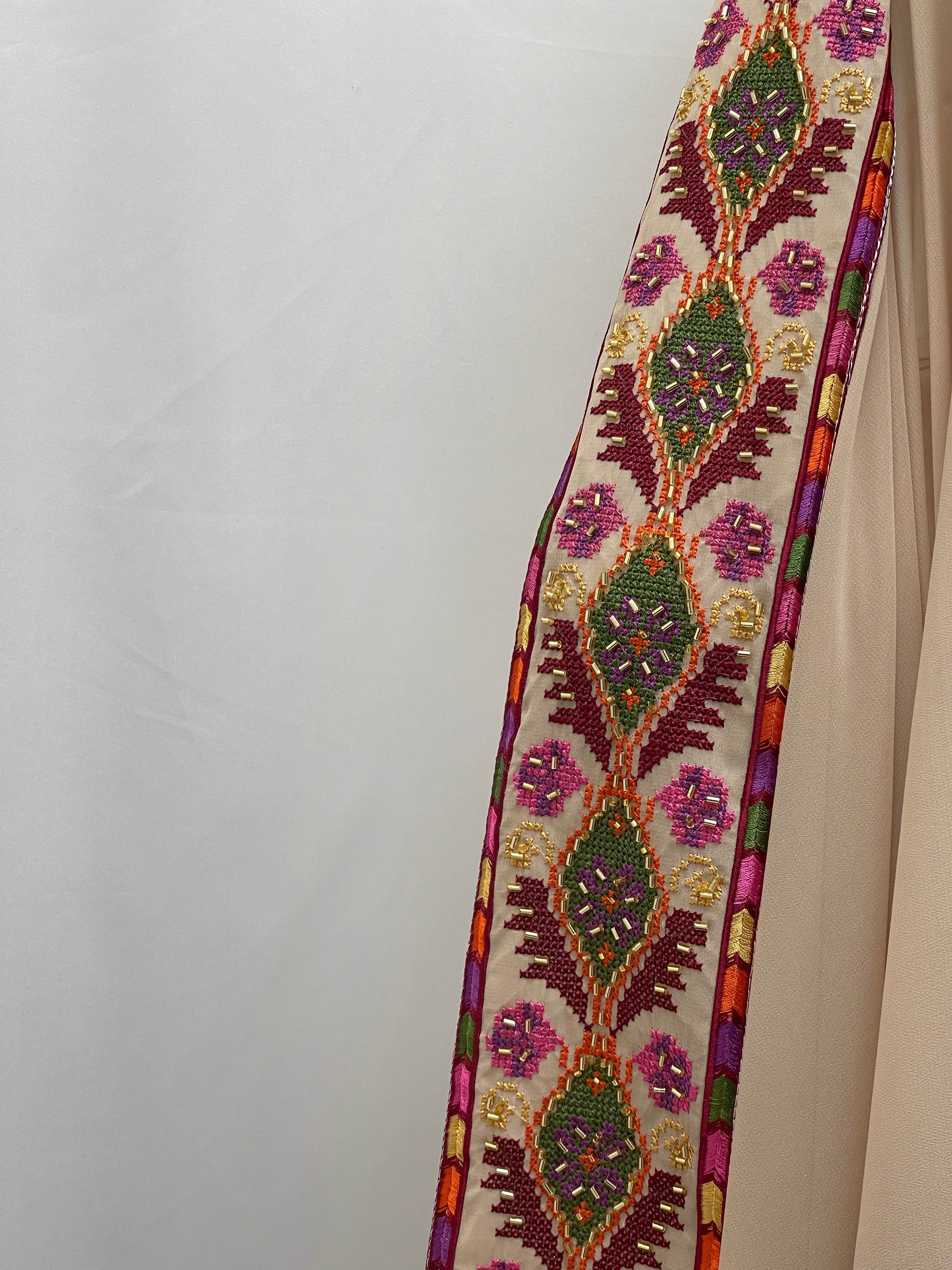 Palestinian Elegance Embroidered Khirka-Shal With Beads featuring intricate colorful embroidery on beige hijab fabric