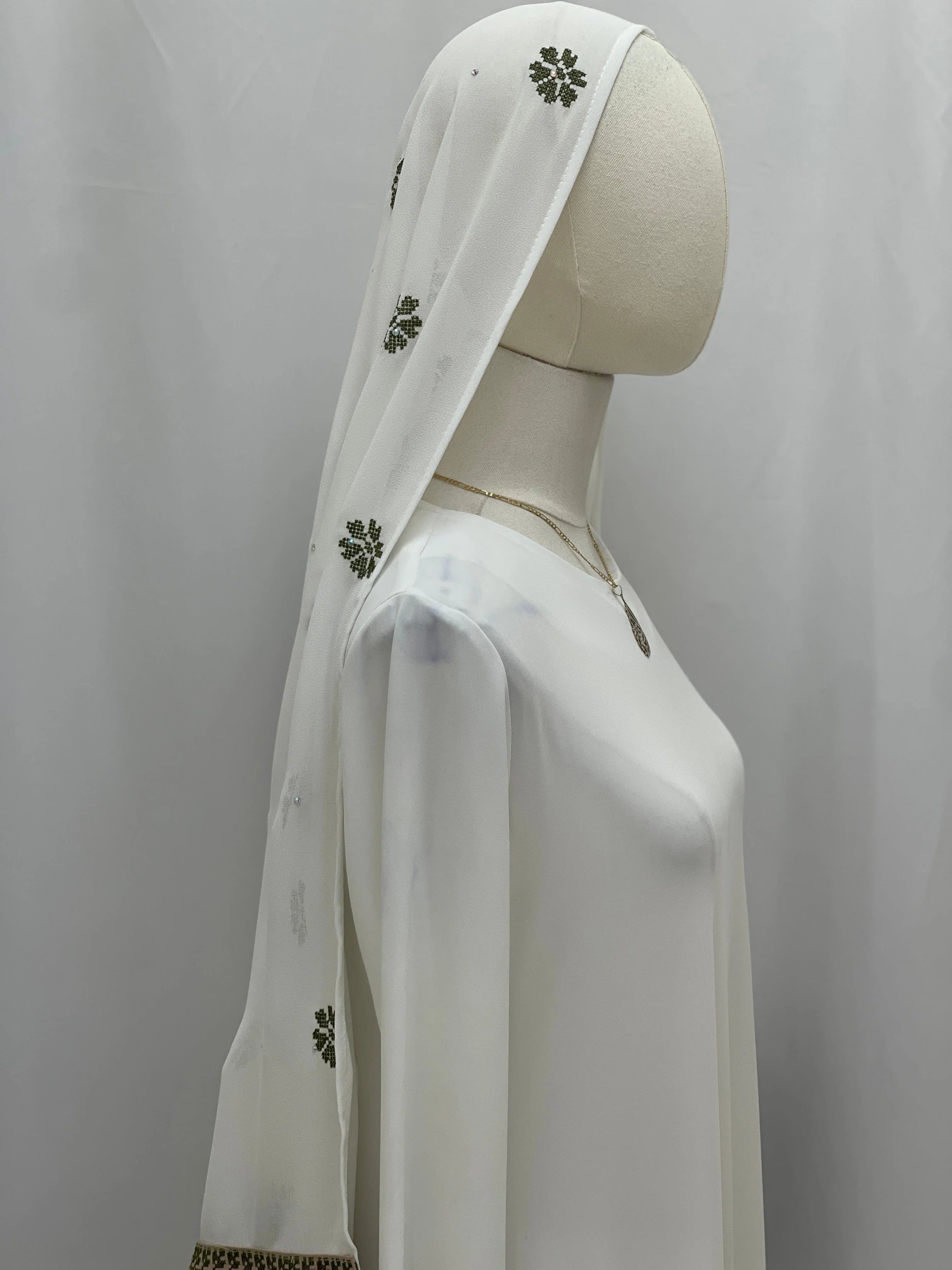 Elegant model showcasing an embroidered khirka with tassels in white, featuring intricate floral designs