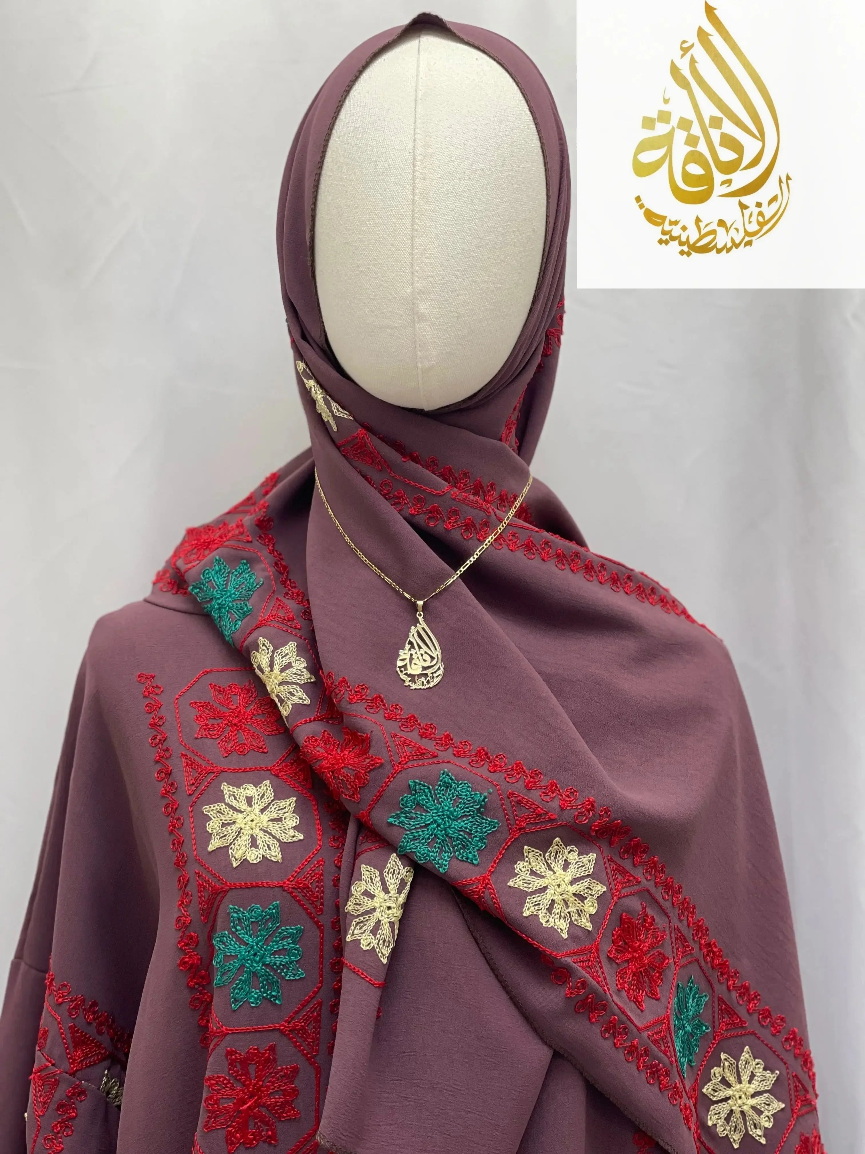 Palestinian Elegance embroidered prayer dress with detailed red, green, and cream floral embroidery on purple fabric