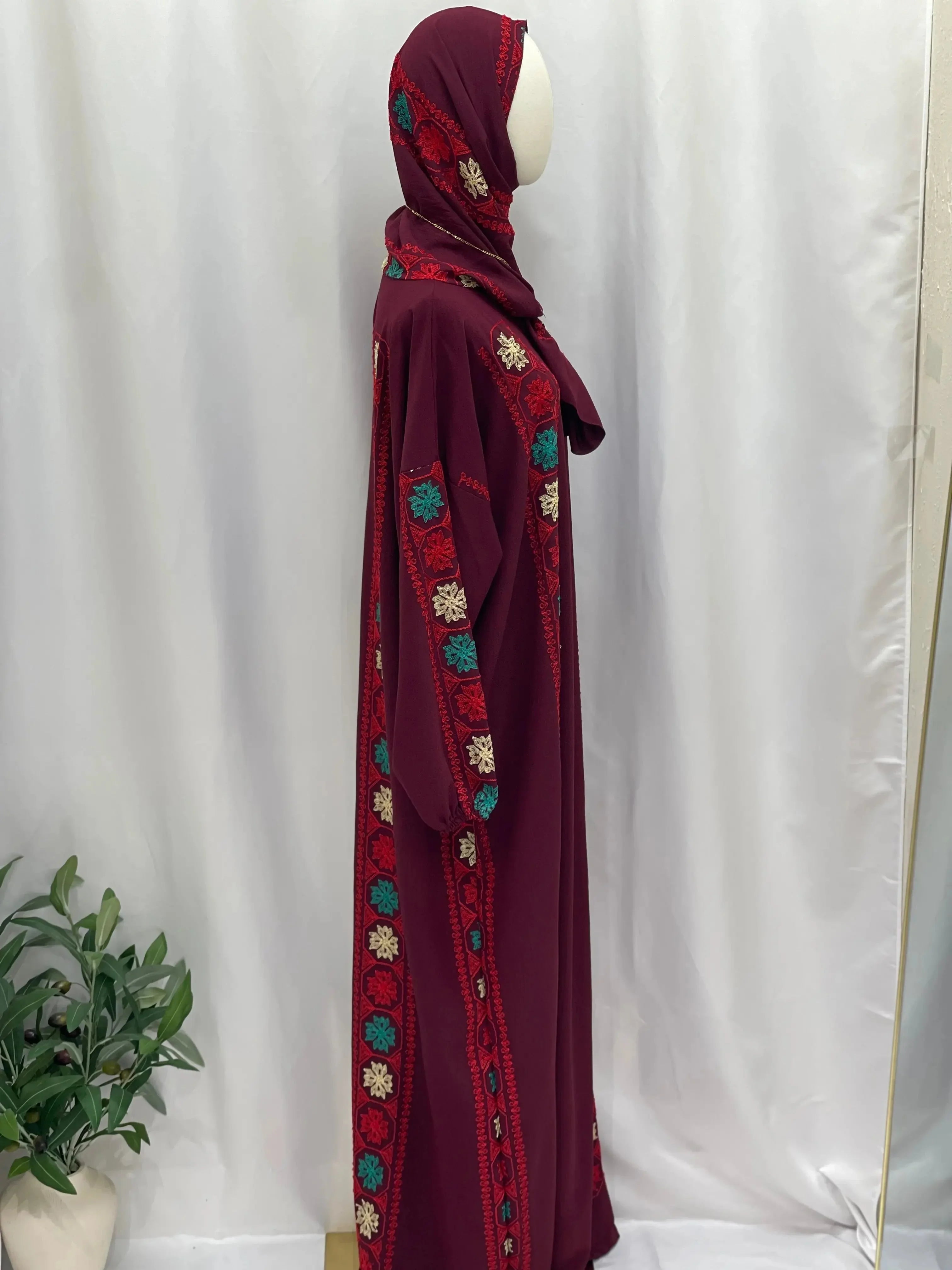 Palestinian Elegance embroidered prayer dress in burgundy with colorful floral embroidery along sleeves and sides