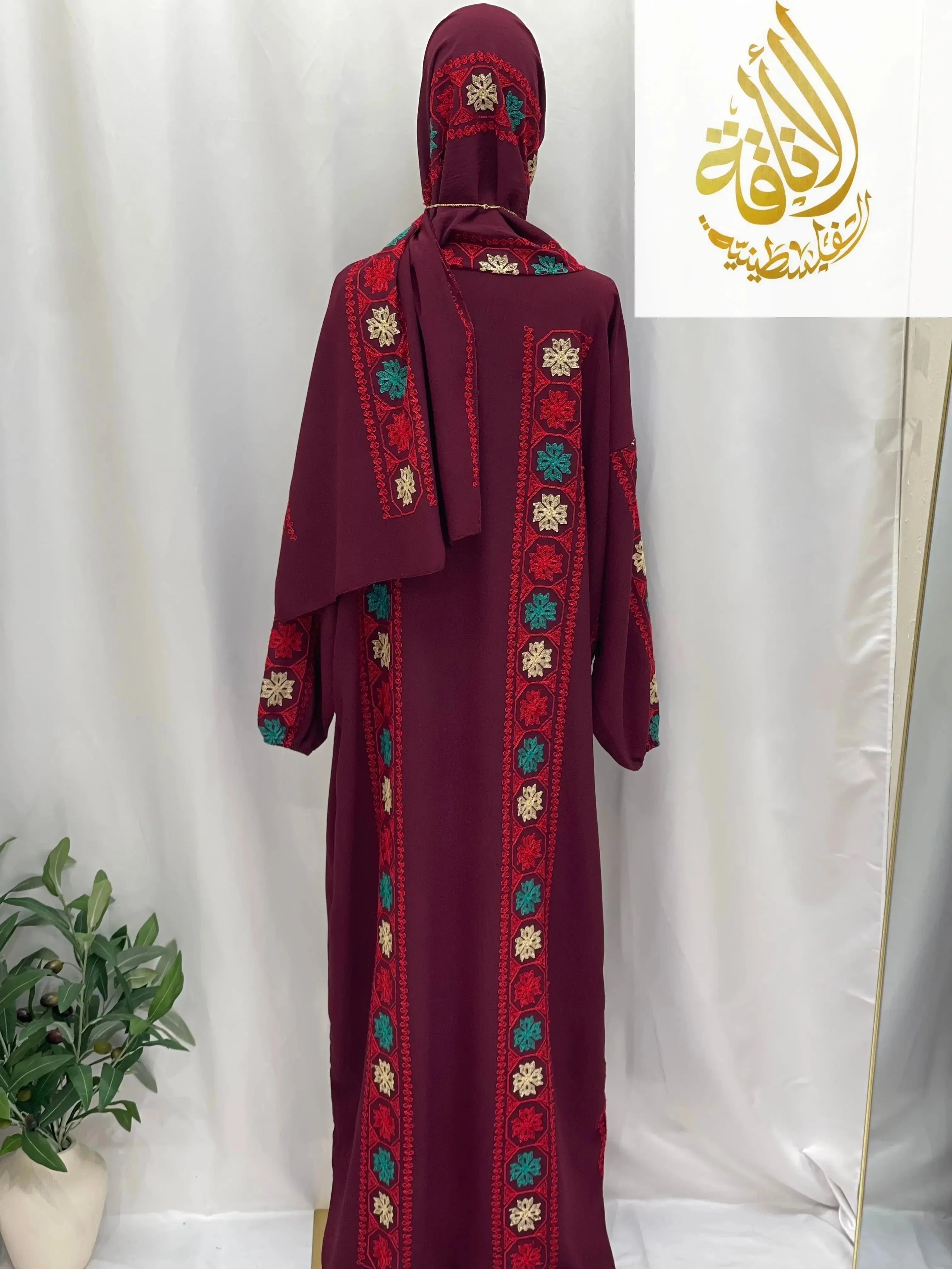 Back view of Palestinian Elegance embroidered prayer dress in deep maroon with colorful floral patterns