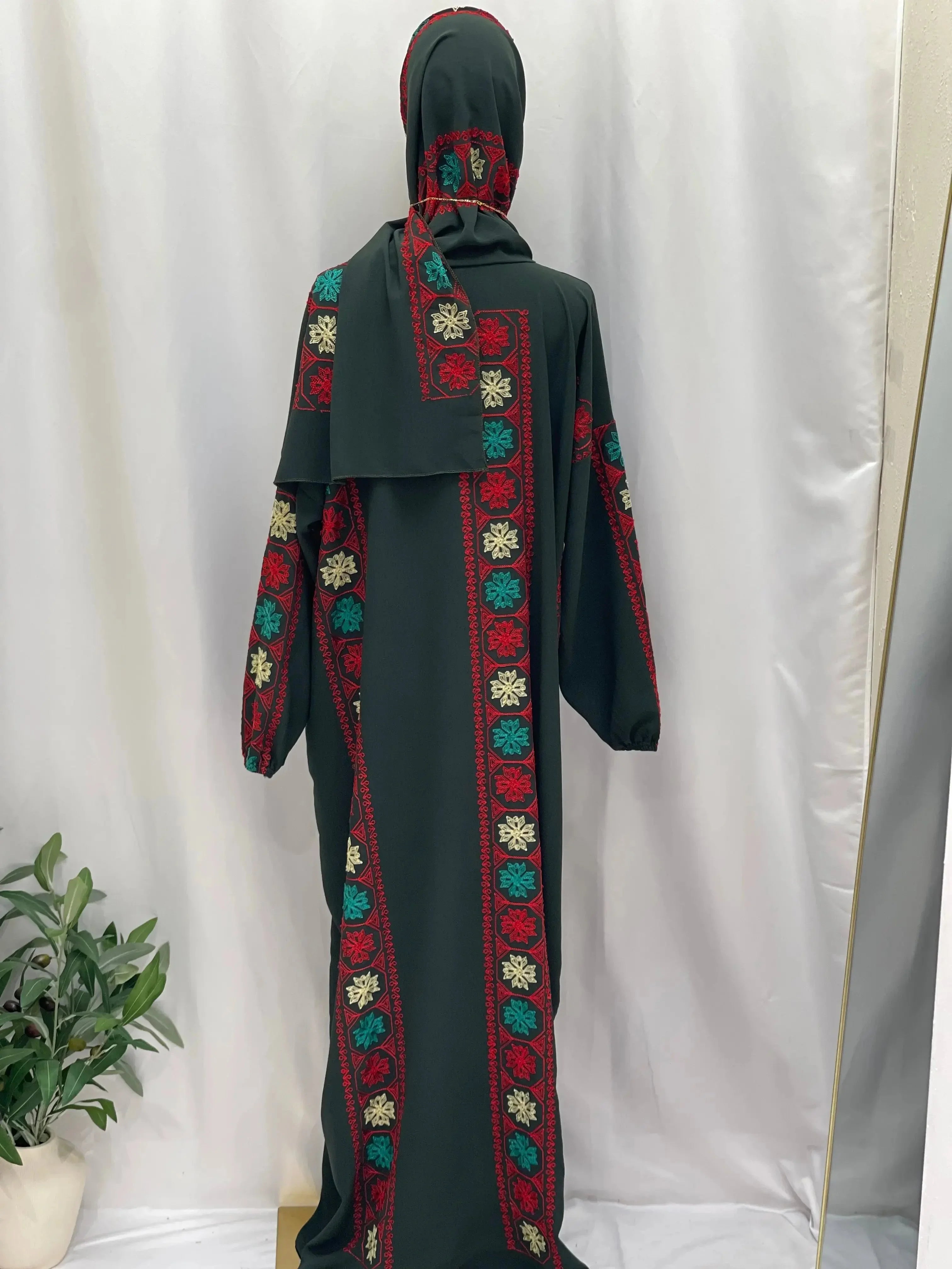 Palestinian Elegance embroidered prayer dress with colorful floral patterns on black fabric and matching headscarf