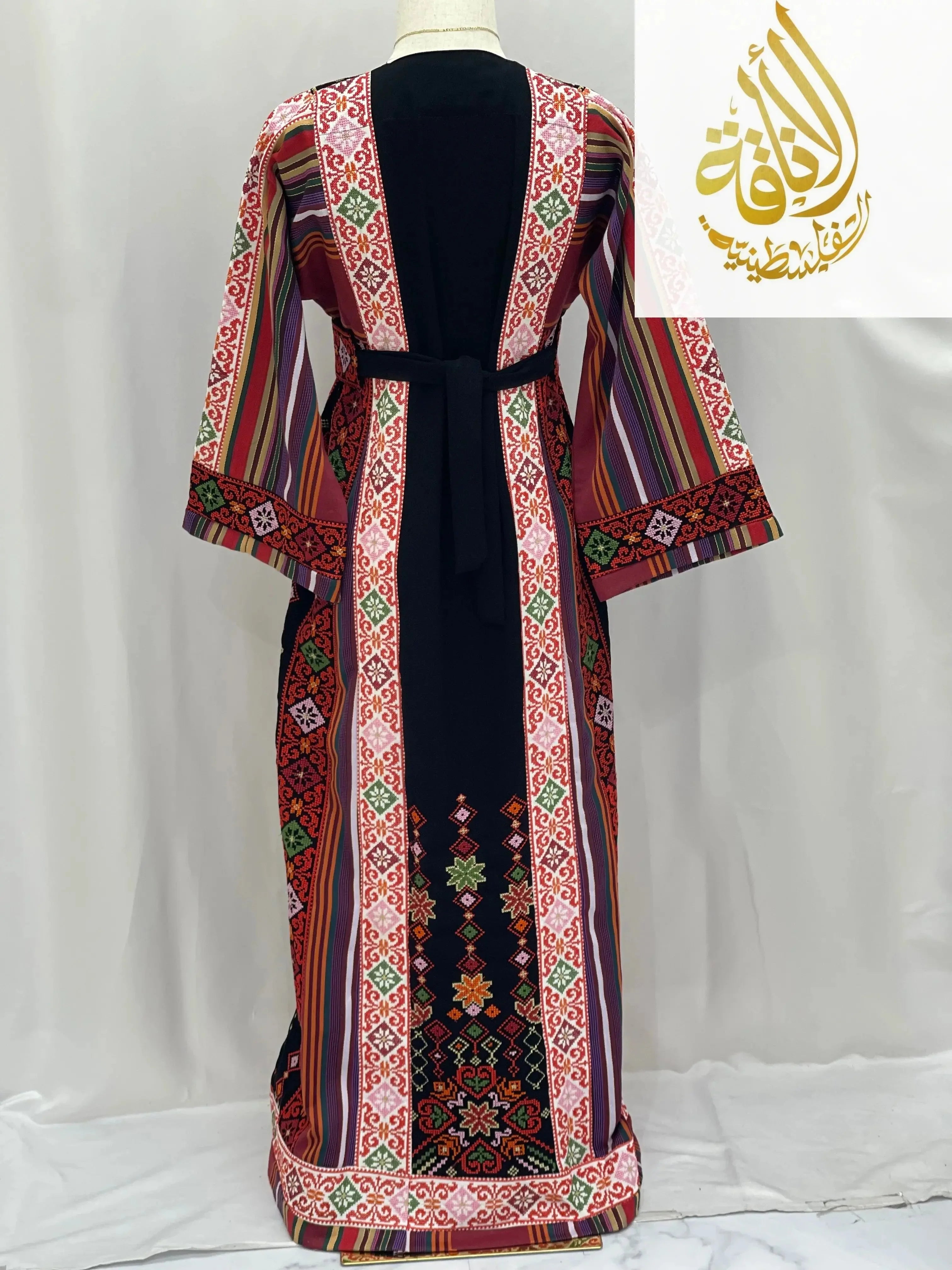 Back view of embroidered thoub for teens with colorful traditional Palestinian Elegance patterns and black center panel
