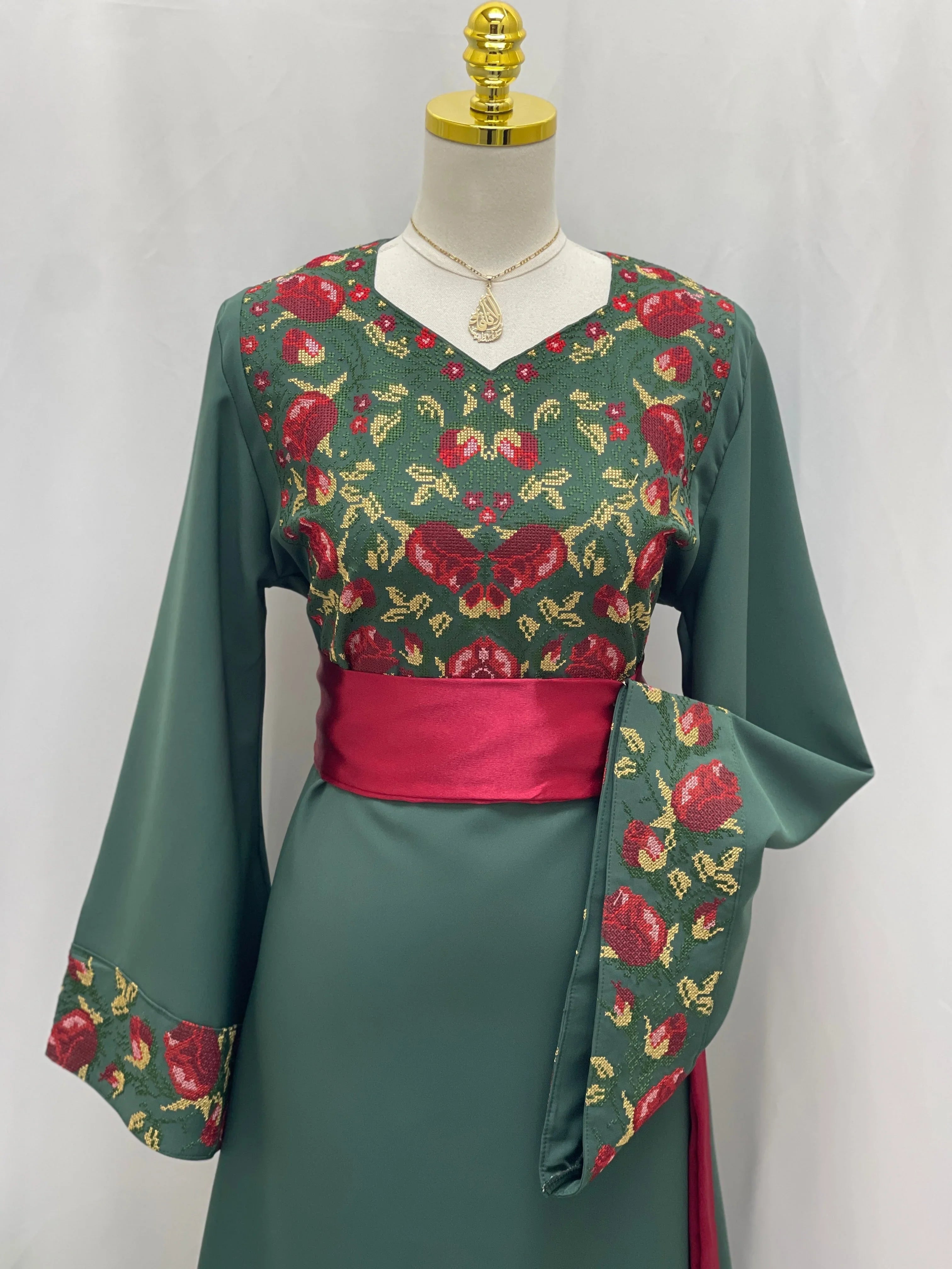 Palestinian Elegance Emerald Blossom EmbroideredThobe green thobe with red floral embroidery and satin sash